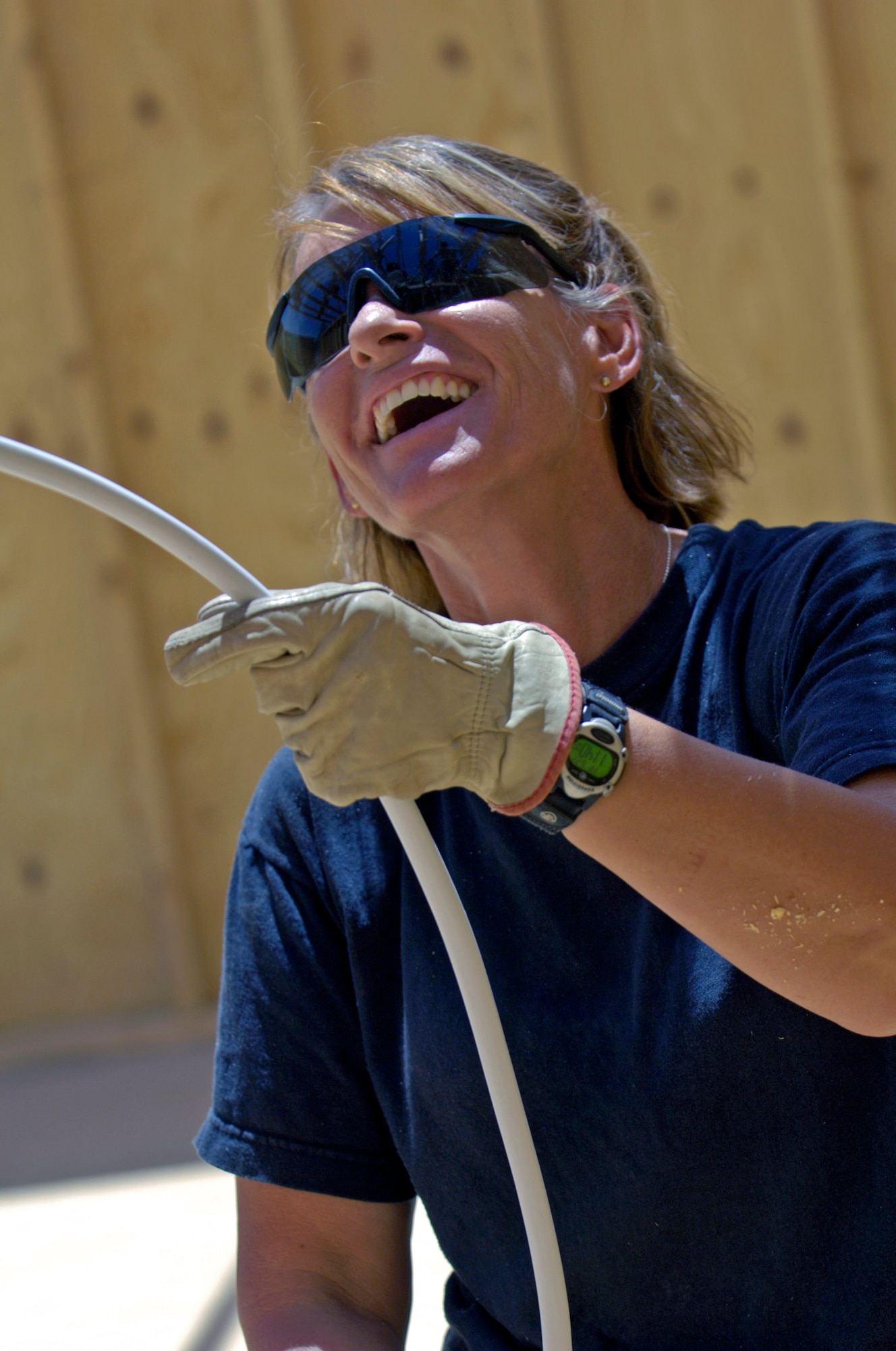 Master Sgt. Lori Bordman runs electrical wires up into the rafters in the first of four tactical operations centers June 22 at Forward Operating Base Kalsu, Iraq. Sergeant Bordman is an electrician with the 557th Expeditionary RED HORSE Squadron and a reservist deployed from Nellis Air Force Base, Nev., and is originally from Copperas Cove, Texas. She and her fellow Rapid Engineer Deployable Heavy Operational Repair Squadron Engineers,or RED HORSE, Airmen are forward deployed from Balad Air Base, Iraq, to build the four tactical operations centers for the Army's 2nd Brigade combat team, 3rd Infantry Division headquartered here. The 2/3 ID are currently running their operations out of tents. The Air Force Red Horse unit was requested by the Army to come into this "Triangle of Death" location because of their self-suffiency and for the multiple skill sets they bring to a project. (U.S. Air Force photo/Master Sgt. Jim Varhegyi)
