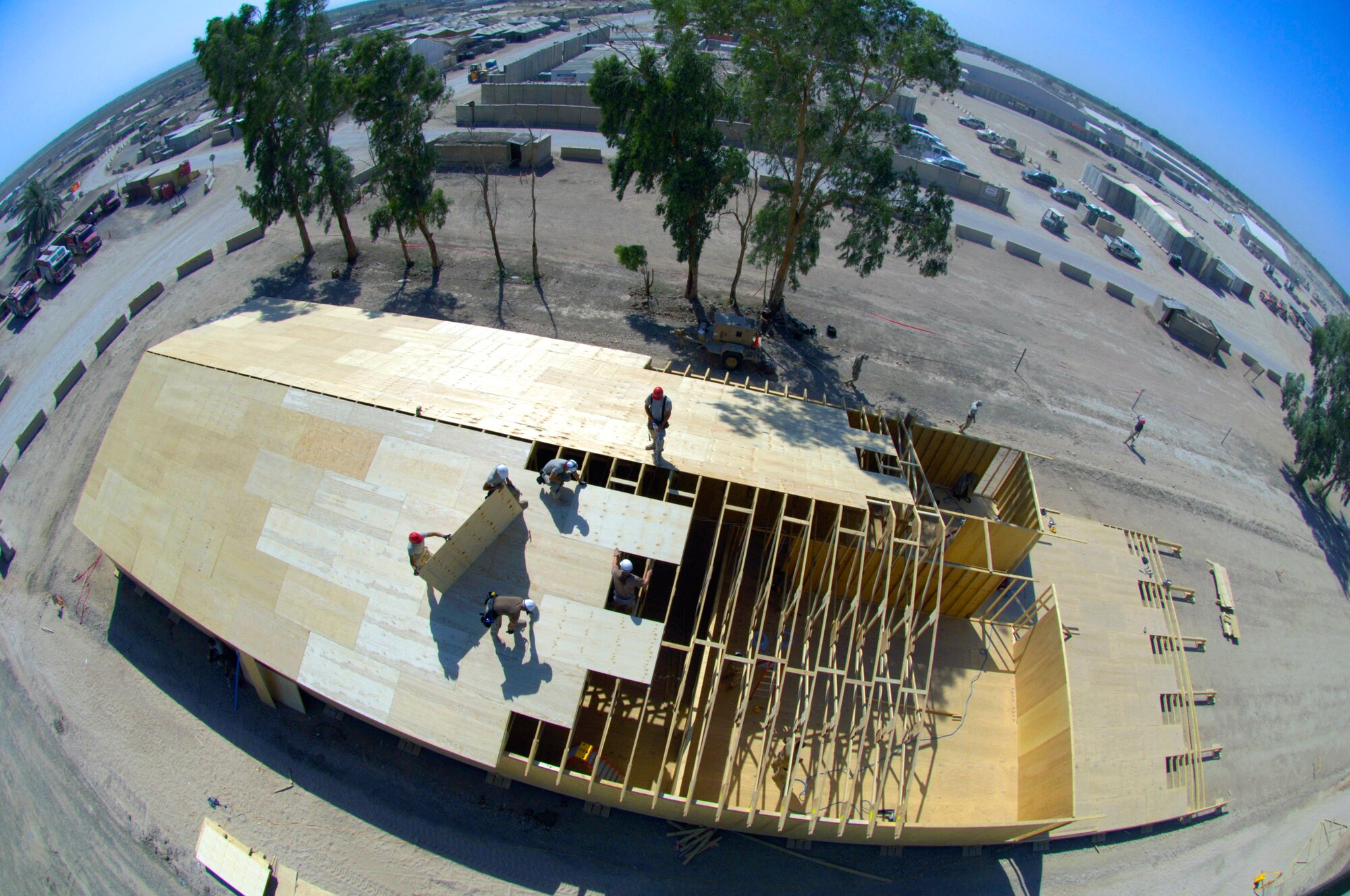 Airmen with the 557th Expeditionary RED HORSE Squadron work on the roof of a tactical operations center June 22 at Forward Operating Base Kalsu, Iraq. The Rapid Engineer Deployable Heavy Operational Repair Squadron Engineers , or RED HORSE, Airmen are forward deployed from Balad Air Base, Iraq, to build four tactical operations centers for the Army's 2nd Brigade combat team, 3rd Infantry Division headquartered here. The 2/3 ID is currently running operations out of tents. The RED HORSE unit, made up of Air Guard, Reserve and active-duty Airmen, was requested by the Army to come into this "Triangle of Death" location because of their self-suffiency and for the multiple skill sets they bring to a project. (U.S. Air Force photo/Master Sgt. Jim Varhegyi)