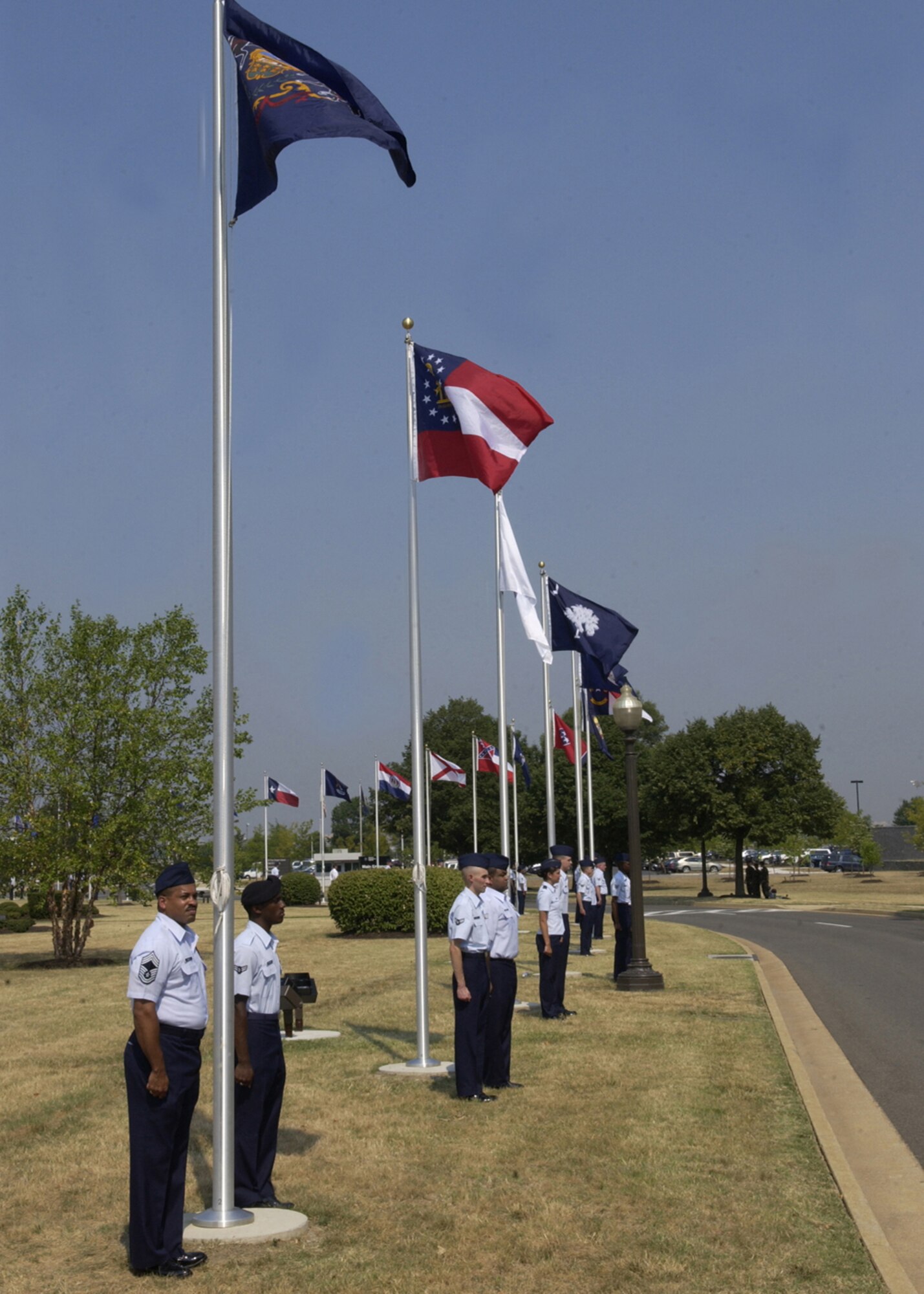 Airmen stand at attention after raising their designated flags during a flag-raising ceremony July 9 as part of the Arnold Gate dedication at Bolling. Re-establishing Bolling’s Avenue of Flags, the ceremony involved the simultaneous rising of 56 different flags by members of the Bolling community representing the 50 states, as well the District of Columbia, Guam, Puerto Rico, American Samoa, Northern Marianna Islands and the U.S. Virgin Islands. (U.S. Air Force photo by Airman 1st Class Sean Adams)