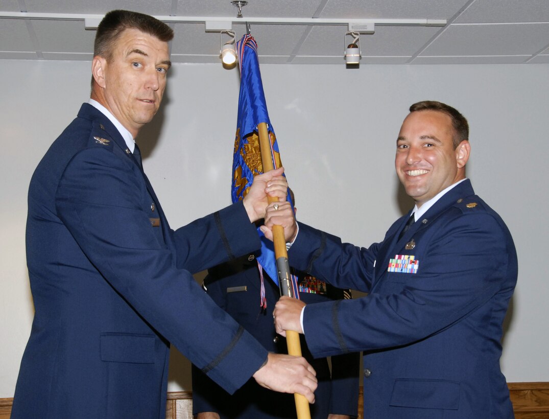 Maj. Robert Hoskins, right, takes command of the 82nd Mission Support Squadron July 9 at an assumption of command ceremony at the Sheppard Club.  82nd Mission Support Group Commander Col. Steven McKay, left, handed over the guidon during the ceremony. (U.S. Air Force photo/Sandy Wassenmiller)