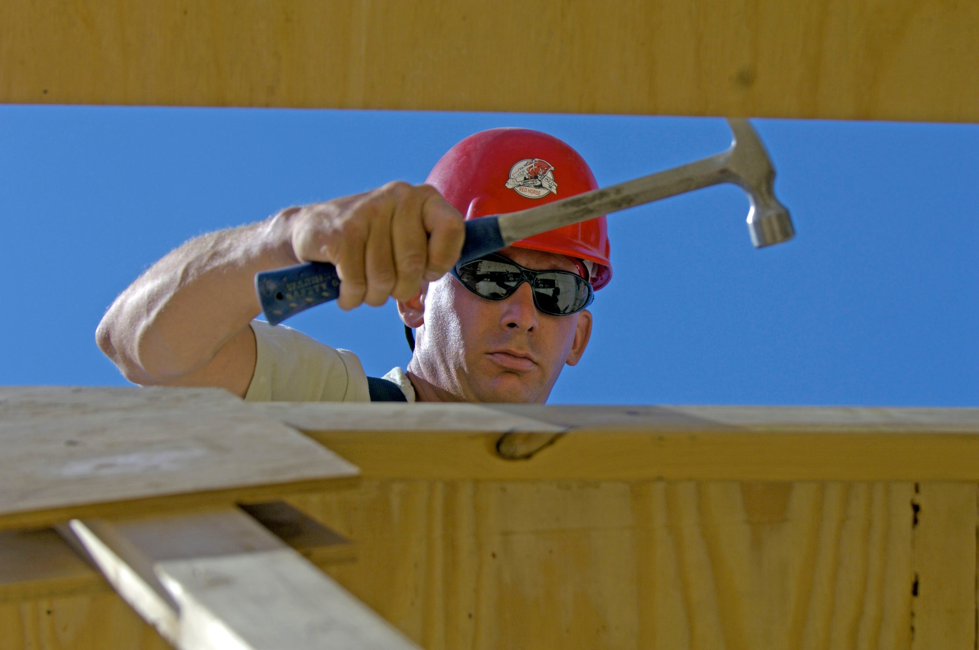 Tech. Sgt. Chris Belknap adjusts the spacing between roof trusses June 22 at at Forward Operating Base Kalsu, Iraq. Sergeant Belknap is the site foreman with the 557th Expeditionary RED HORSE Squadron, one of the Rapid Engineer Deployable Heavy Operational Repair Squadron Engineers, or RED HORSE, Airmen who are forward deployed from Balad Air Base, Iraq and tasked to build four tactical operations centers for the Army's 2nd Brigade combat team, 3rd Infantry Division headquartered here. The 2/3 ID is currently running operations out of tents. The RED HORSE unit, made up of Air Guard, Reserve and active-duty Airmen, was requested by the Army to come into this "Triangle of Death" location because of their self-suffiency and for the multiple skill sets they bring to a project. (U.S. Air Force photo/Master Sgt. Jim Varhegyi)
