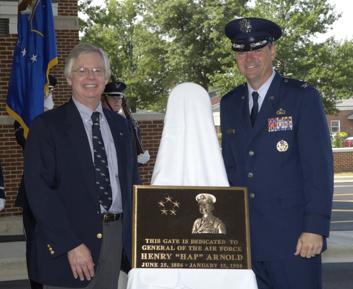 Robert Arnold, grandson of Gen. Henry H. “Hap” Arnold, the first and only five-star General of the Air Force (1949), and Col.Terry Ross, 11th Wing vice commander, unveil the General Arnold dedication plaque during the Main Gate and Avenue of Flag Dedication Ceremony on Bolling July 9.  (U.S. Air Force photo by Staff Sgt. Catherine Thompson)