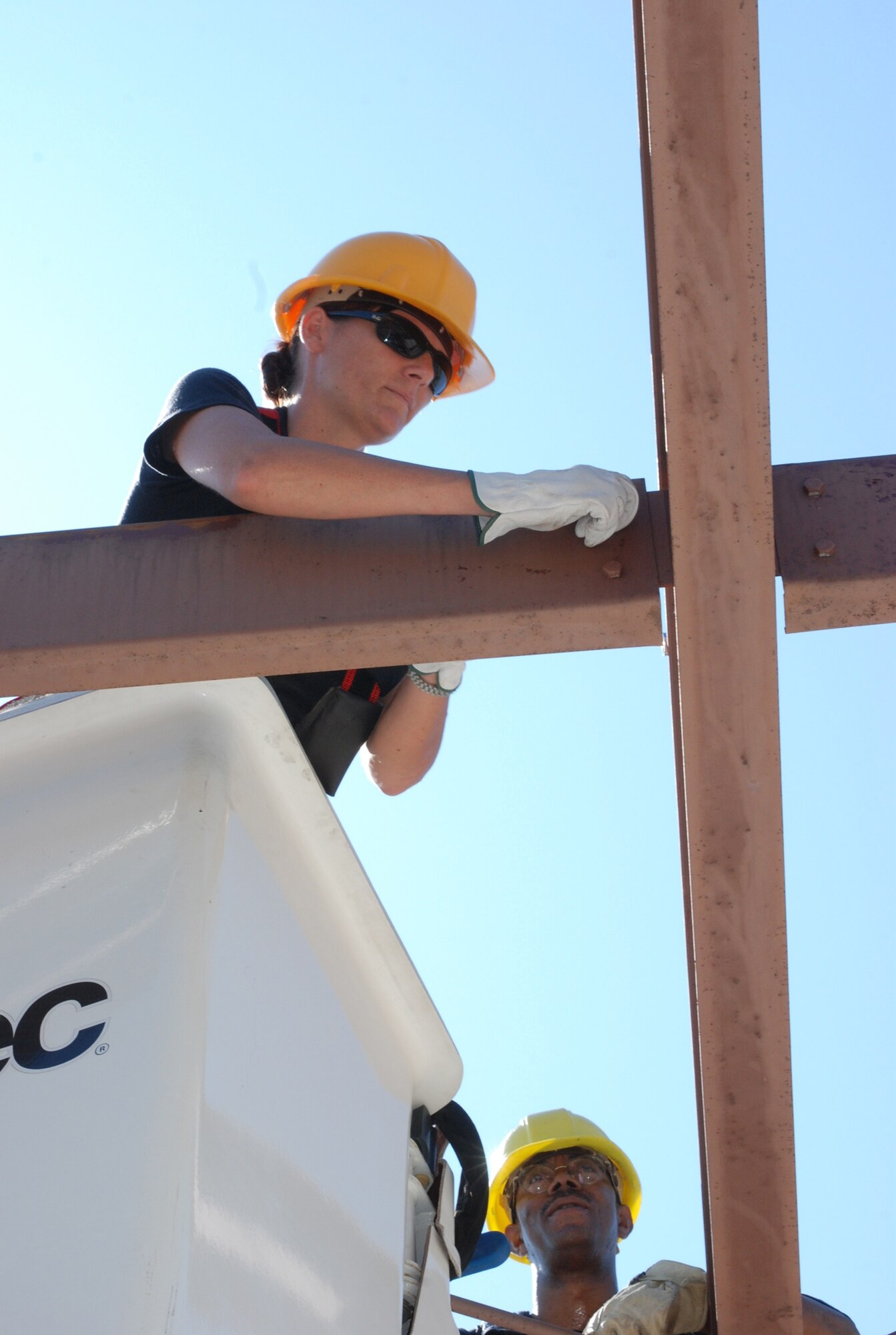 Staff Sgt. Krista Kenoyer, a structural craftsman from the 301st Civil Engineer Squadron, unbolts a support beam while Tech. Sgt. Julius Gordon, an electrical craftsman, looks on for safety issues. The CE team worked together to disassemble the entire building’s frame located at the Naval Air Station Joint Reserve Base, Fort Worth, Texas. (U.S. Air Force Photo/Tech. Sgt. Julie Briden-Garcia)