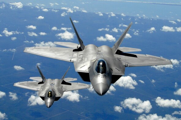 Two F-22 Raptors fly in formation above Florida. Its combination of stealth, supercruise, maneuverability, and integrated avionics, coupled with improved supportability, represents an exponential leap in warfighting capabilities. The F-22 performs both air-to-air and air-to-ground missions allowing full realization of operational concepts vital to the 21st century Air Force. (U.S. Air Force photo/Senior Master Sgt. Thomas Meneguin) 
