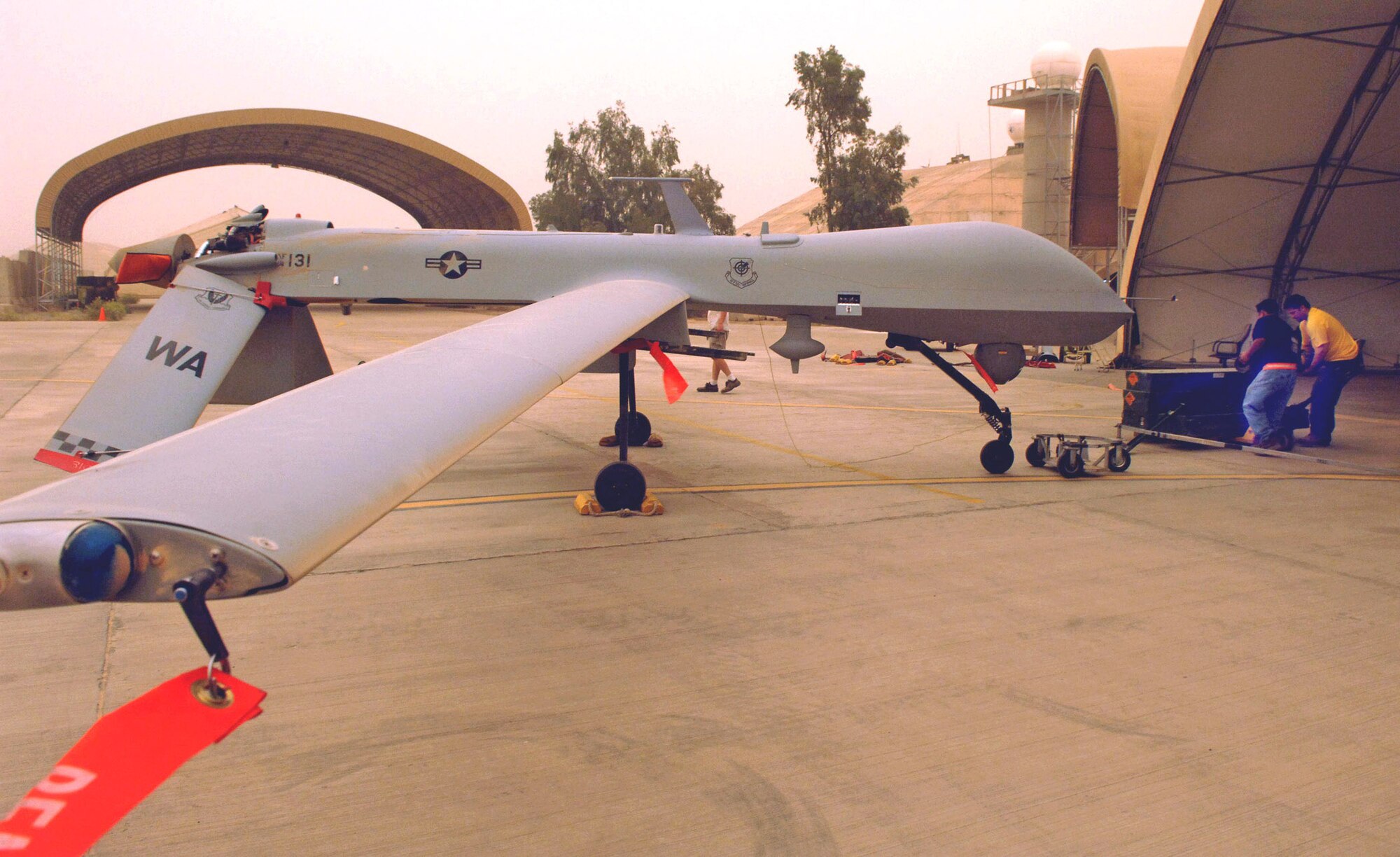 Ben Roserug and Jim Dooley work on an MQ-1 Predator unmanned aerial vehicle at Balad Air Base, Iraq, May 17 that had just returned from a mission. The Predator provides armed reconnaissance, airborne surveillance and target acquisition for coalition forces in Iraq and Afghanistan. (U.S. Air Force photo/Airman 1st Class Jonathan Steffen)