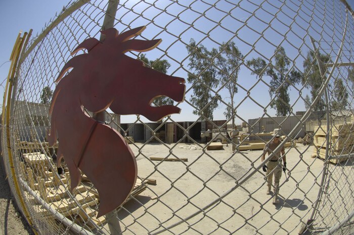Airmen from the U.S. Air Force's 557th Expeditionary RED HORSE Squadron (ERHS), scrounged for scrap material to cobble together a compound for securing equipment and material, which will be used to build tactical operations centers  (TOCs), Friday, June 22. The Rapid Engineer Deployable Heavy Operational Repair Squadron Engineers RED HORSE Airmen are forward deployed from Balad Air Base, Iraq, to build four tactical operations centers (TOCs) for the Army's 2nd Brigade combat team, 3rd Infantry Division headquartered here. The 2/3 ID is currently running operations out of tents. The Air Force RED HORSE unit, made up of Air Guard, Reserve and active duty Airmen, was requested by the Army to come into this "Triangle of Death" location because of their self-suffiency and for the multiple skill sets they bring to a project. Besides the TOCs, the RED HORSE Airmen are working on several other projects at the FOB. (U.S. Air Force photo by Master Sgt. Jim Varhegyi)