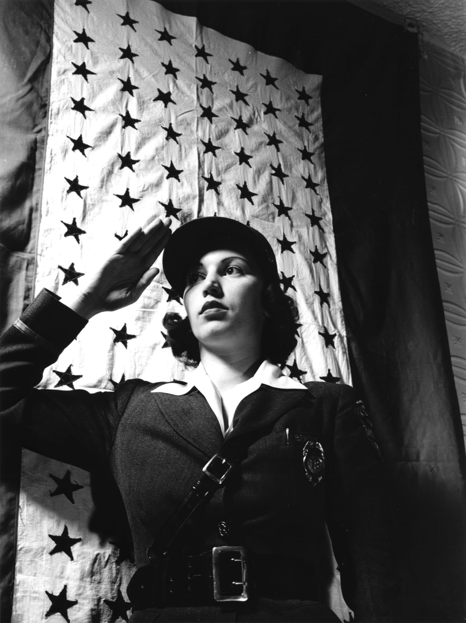 The Bendix Aviation plant, Brooklyn, New York, showed its pride in its employee service members with this very large service flag during World War II. A plant guard salutes in this March 1943 photo. (U.S. Air Force photo)