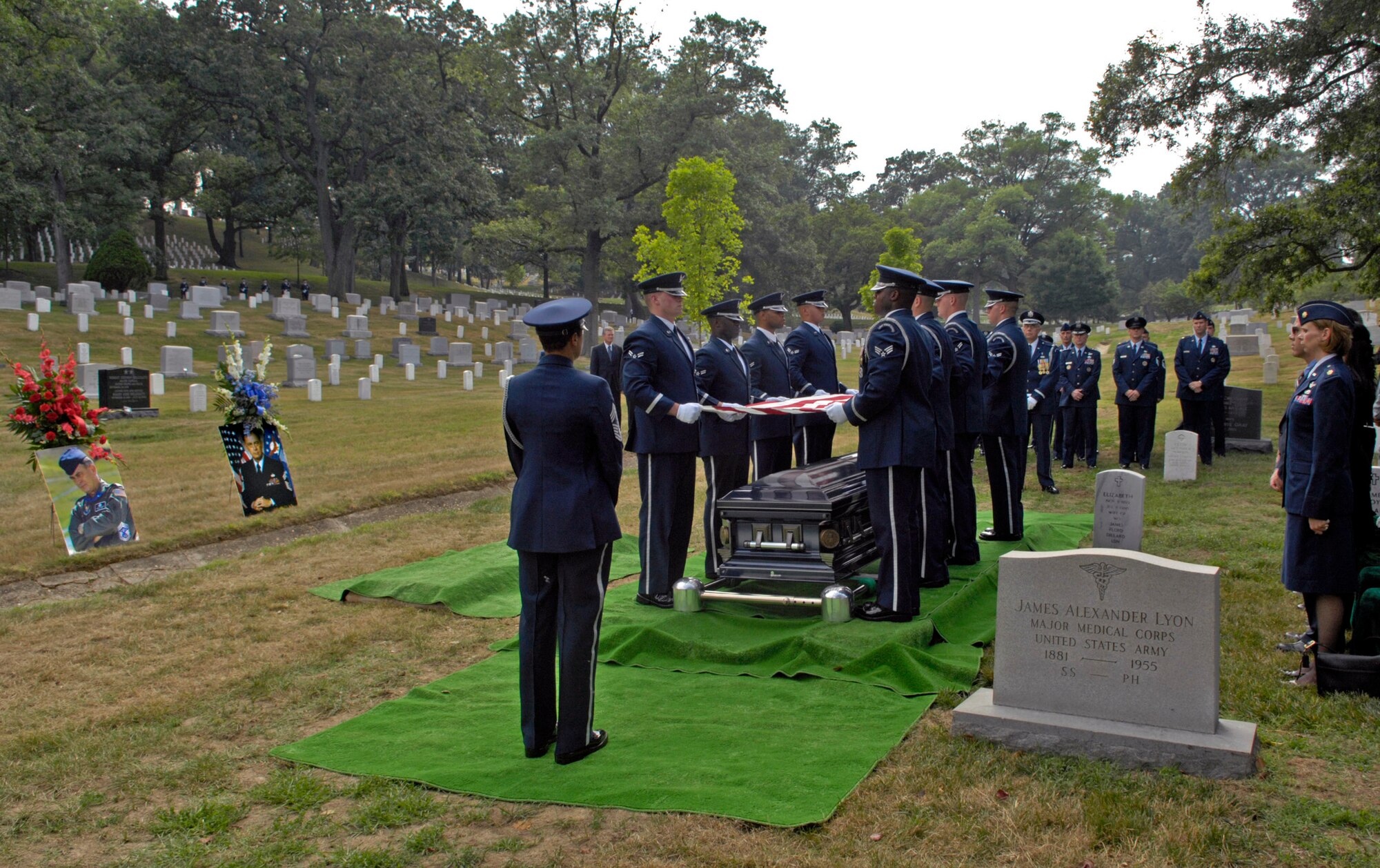 Air Force Honor Guard pallbearers hold the United States flag over coffin of the late Chief Master Sergeant of the Air Force Gary R. Pfingston at his burial site July 6 at Arlington National Cemetery, Va.  The 10th CMSAF was born in Evansville, Ind., and entered the Air Force in February 1962. He passed away June 23 in San Antonio. (U.S. Air Force photo/Senior Airman Rusti Caraker)
