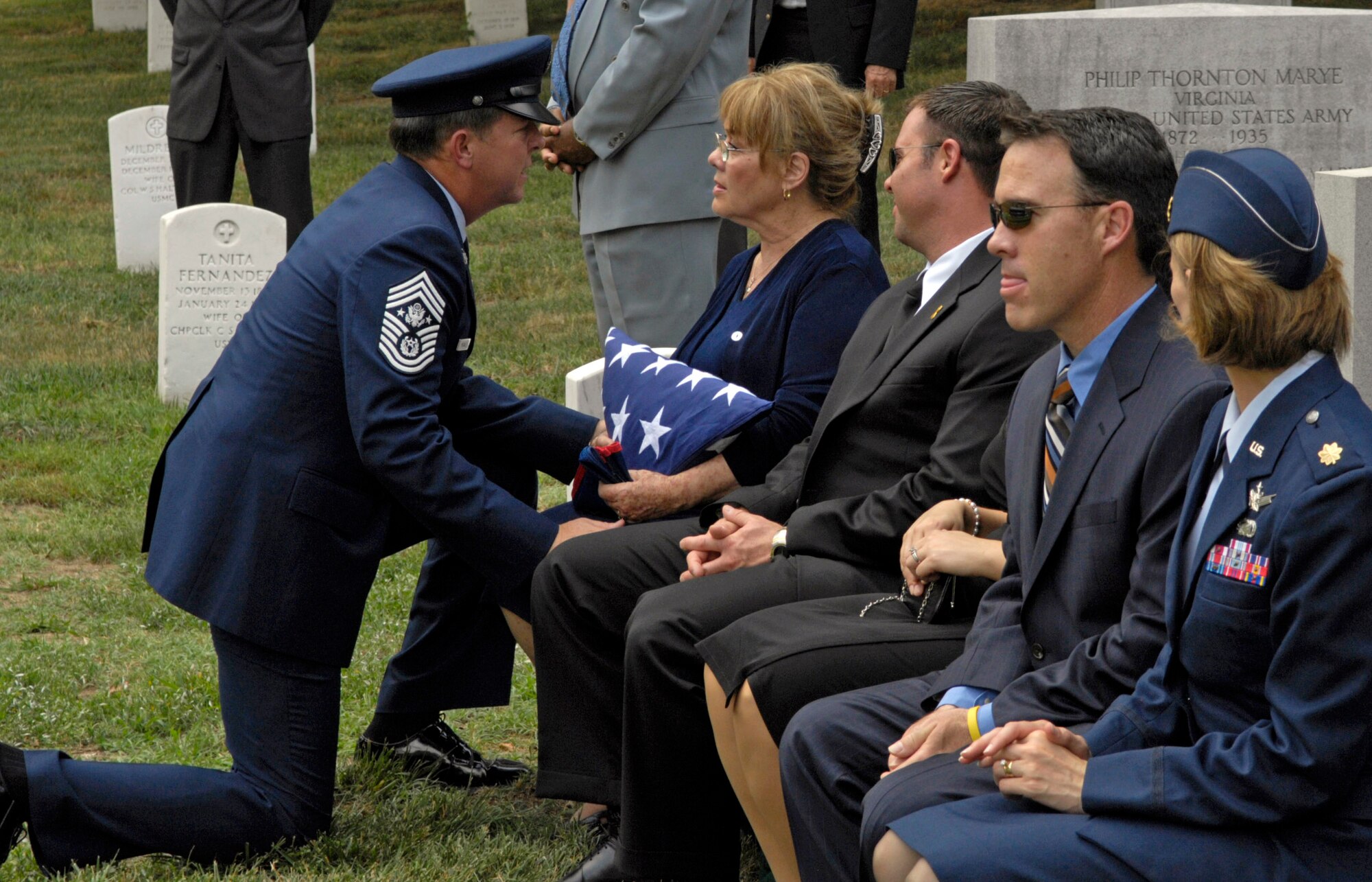 Chief Master Sergeant of the Air Force Rodney J. McKinley gives his regards to the family of former Chief Master Sergeant of the Air Force Gary R. Pfingston at his burial site July 6 at Arlington National Cemetery, Va.  Chief Pfingston, the 10th CMSAF, was born in Evansville, Ind., and entered the Air Force in February 1962. He passed away June 23 in San Antonio. (U.S. Air Force photo/Senior Airman Rusti Caraker)