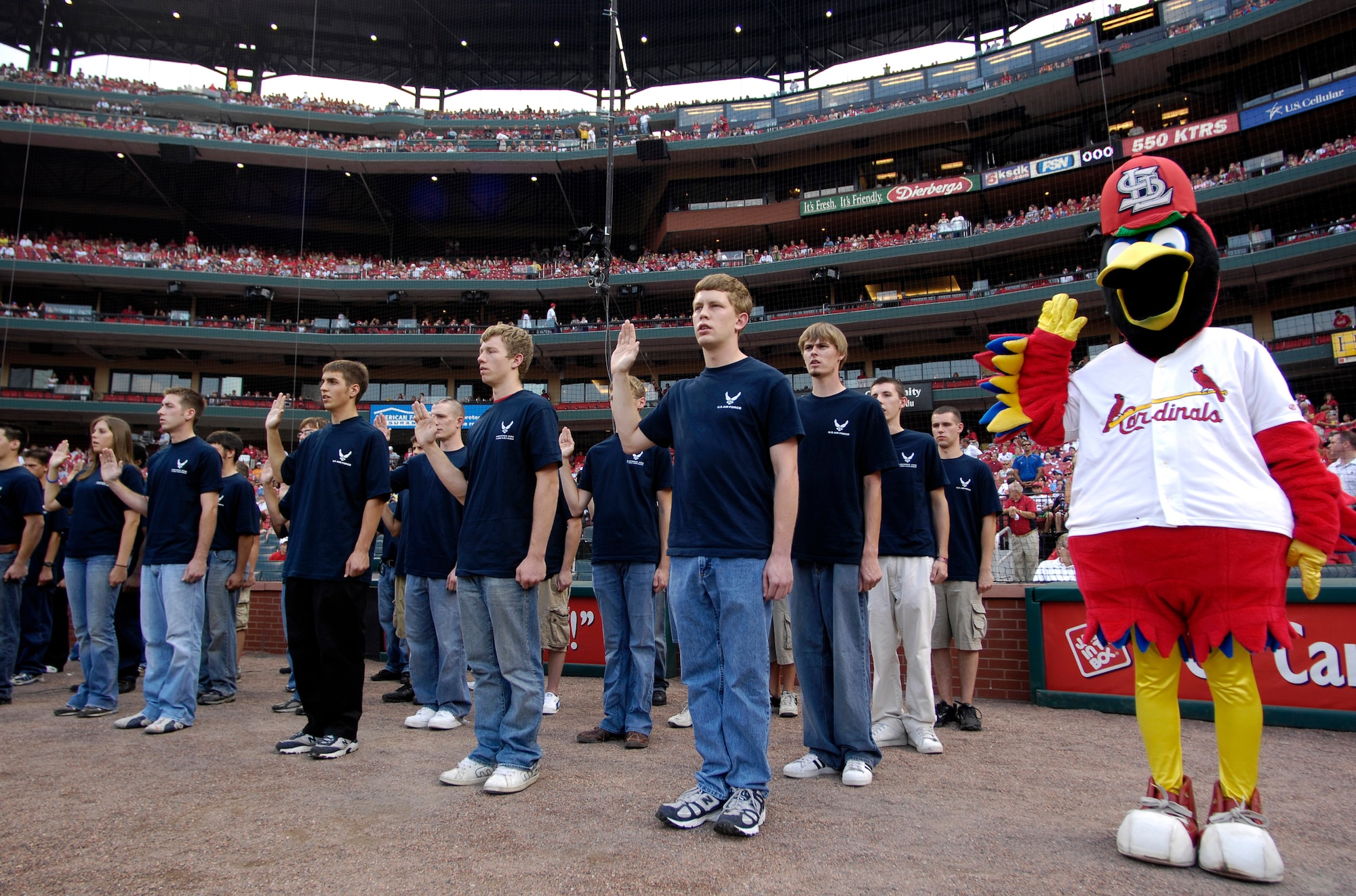 Fredbird, the St. Louis Cardinal mascot, joins in as 40 young men and women are sworn into the Air Force by Gen. Duncan J. McNabb, Air Mobility Command commander at nearby Scott Air Force Base, Ill., prior to the Cardinals-Giants baseball game July 7.  The soon-to-be Airmen were enlisted during pregame activities that were part of Air Force Week in St. Louis. (U.S. Air Force photo/Staff Sgt. Brian Ferguson)
