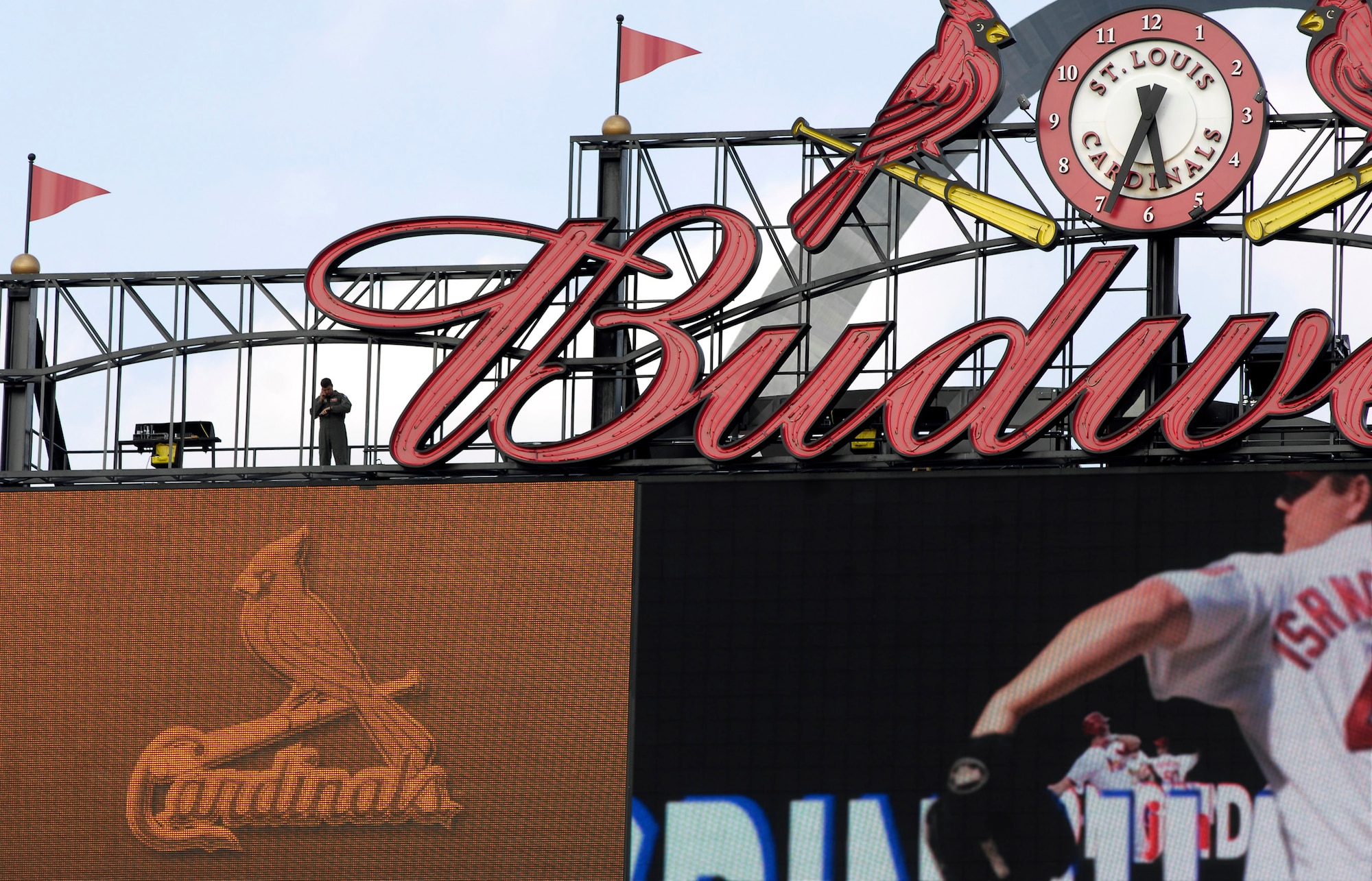 High atop the St Louis Cardinals scoreboard, Capt. Dan Simpson calls in a C-17 Globemaster III as the National Anthem comes to an end before a Cardinals-Giants baseball game July 7.  The flyover was part of Air Force Week St. Louis. (U.S. Air Force photo/Staff Sgt. Brian Ferguson)