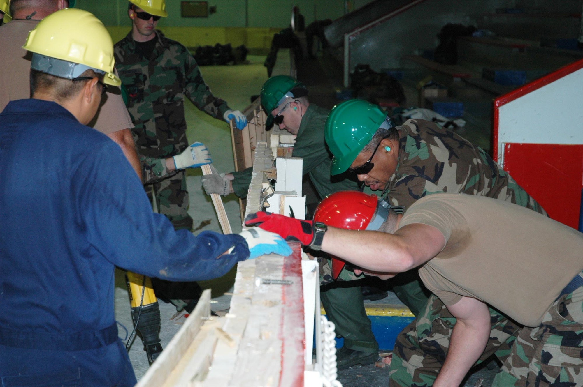 Members of the 147th Civil Engineer Squadron take down walls as Exercise Winged Beaver begins. (Texas National Guard photo/Senior Master Sgt. Marcus Falleaf)