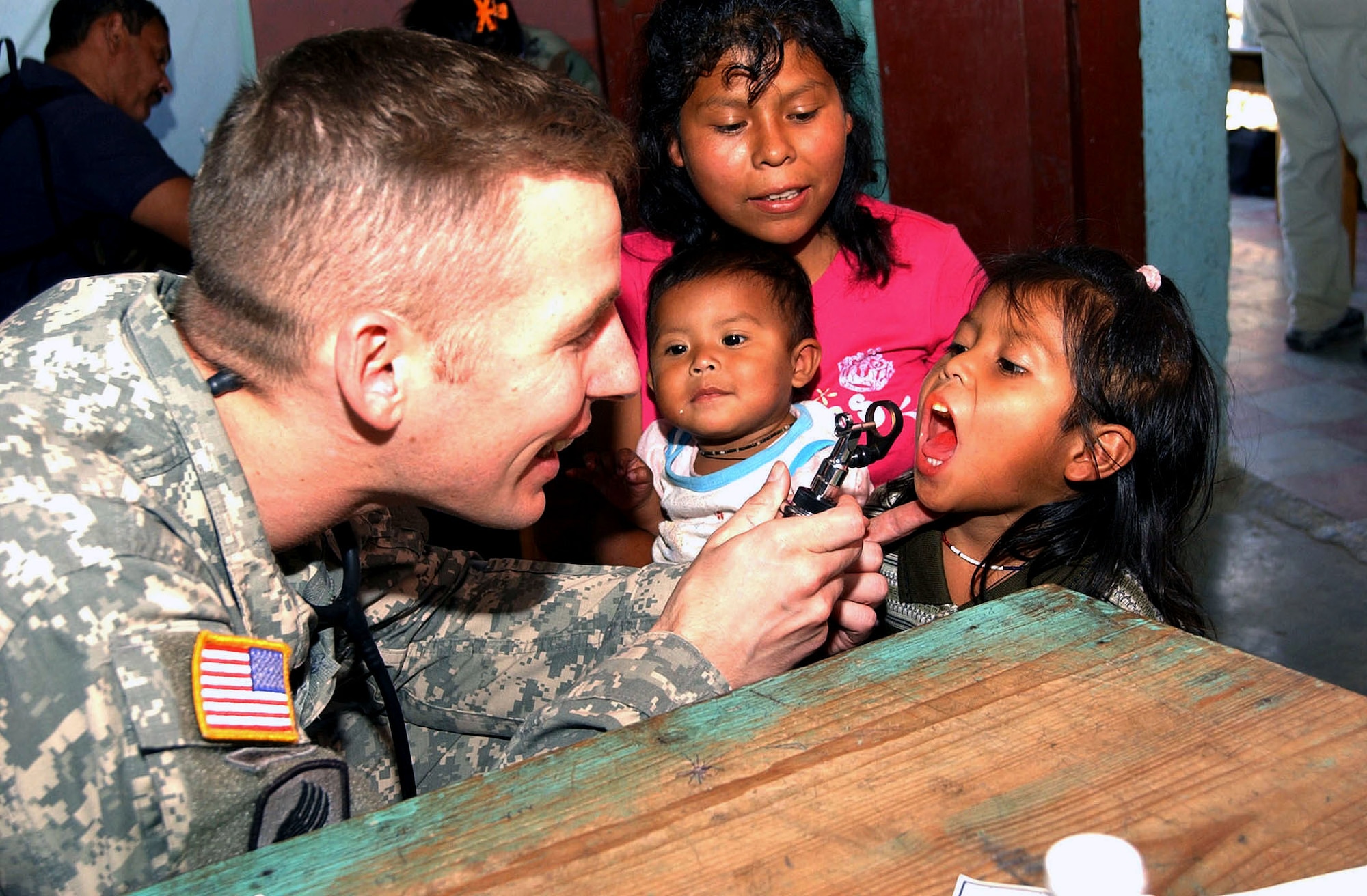 Army Maj. (Dr.) Richard Malish examines a child during a Medical Readiness Training Exercise June 29 in El Horno, Honduras. The medical team saw 1,072 patients during the two-day mission. Major Malish is a cardiologist and the flight surgeon at Soto Cano Air Base, Honduras.(U.S. Air Force photo/Tech. Sgt. Sonny Cohrs) 
               