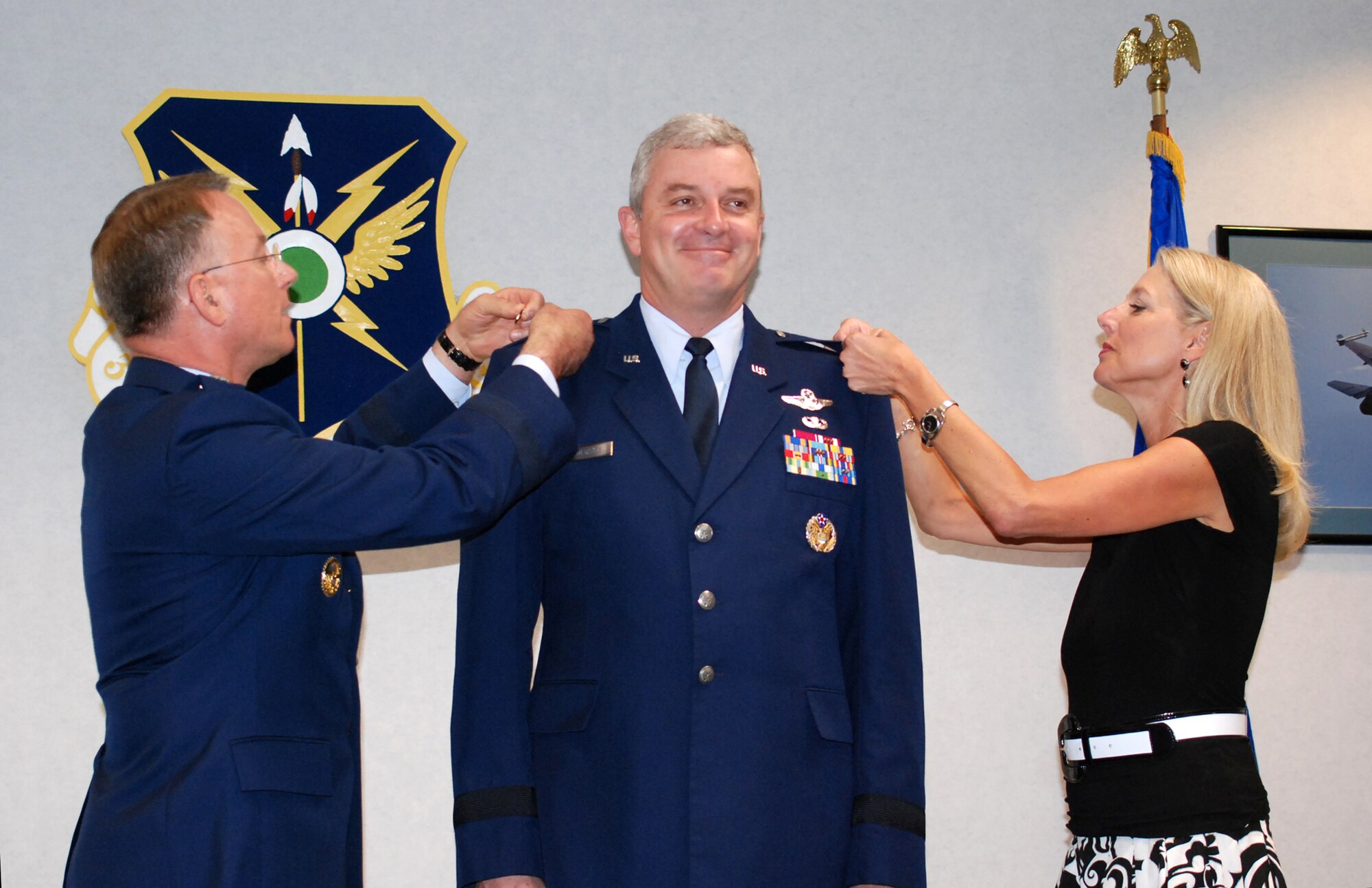 Lt. Gen. John Bradley, Chief of Air Force Reserve, Headquarters U.S. Air Force, and Commander, Air Force Reserve Command, assists Kay Anderson in pinning on Brig. Gen. Frank Anderson's first star in a ceremony at the 301st Fighter Wing at Naval Air Station Joint Reserve Base Fort Worth, Texas, on July 7, 2007. Gen. Anderson was previously the 301st Logistics Group commander before his current position as MA to the director of operations and training, headquarters Air Force, Pentagon. (U.S. Air Force Photo/Tech. Sgt. Julie Briden-Garcia)