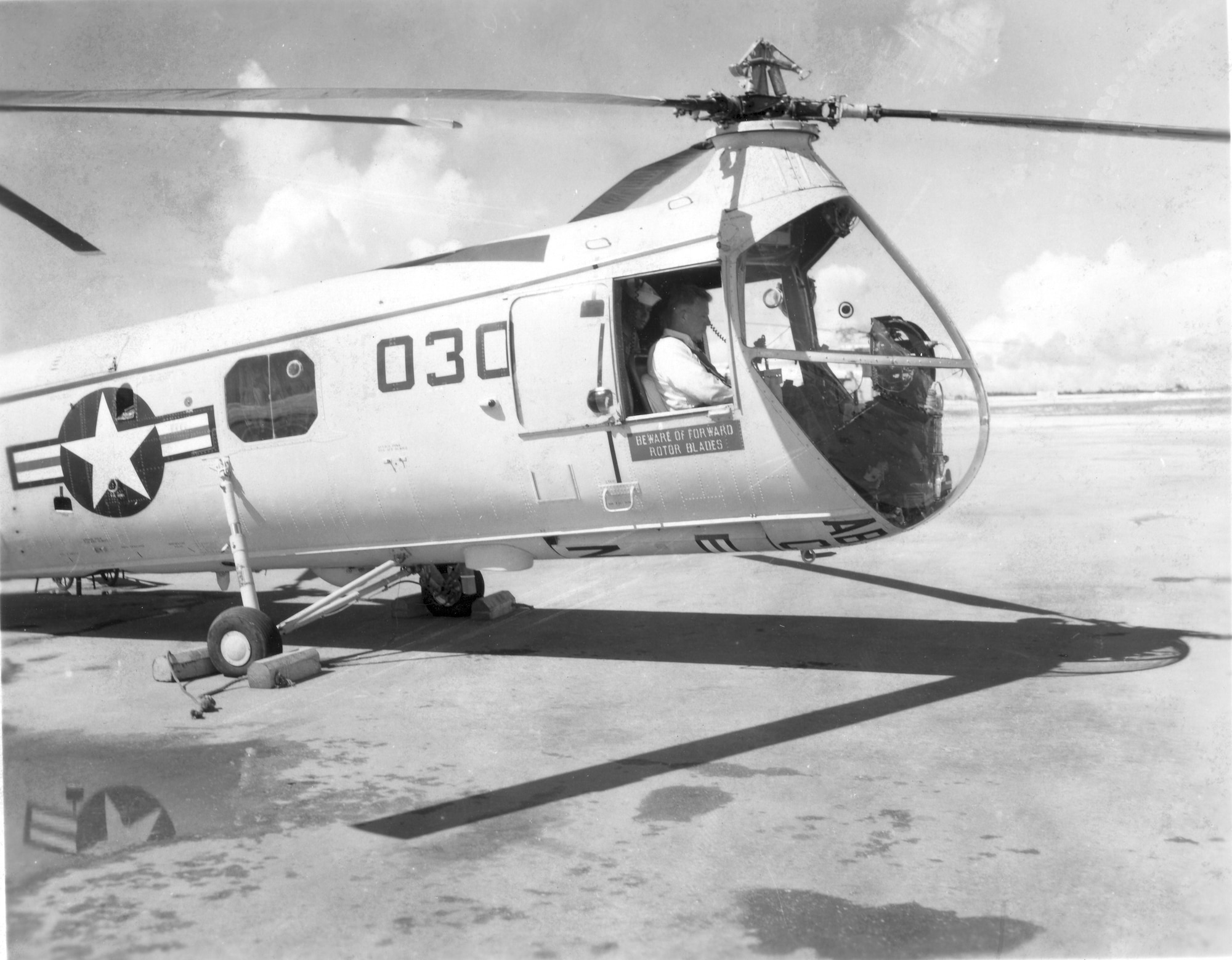 Former Defense Secretary Neil McElroy sits in the cockpit of an air-rescue helicopter as it prepares to take flight in October 1958. (Courtesy of the 36th Wing History Office)
