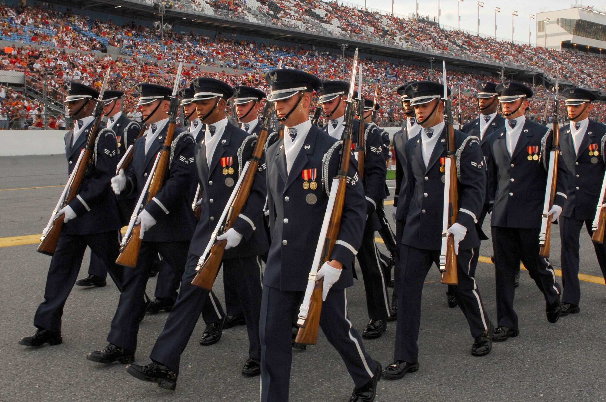 Members of the Drill Team march out of pit row following their large 16-man performance. More than 150,000 watched, as TNT broadcast the Air Force performance live during the pre-race events at NASCAR's Pepsi 400 in Daytona, Fla. on July 7th. The Drill Team is the traveling component of the Air Force Honor Guard and tours Air Force bases world wide showcasing the precision of today's Air Force to recruit, retain, and inspire Airmen for the Air Force mission. (U.S. Air Force photo by Airman 1st Class Alexandre Montes)(Released)