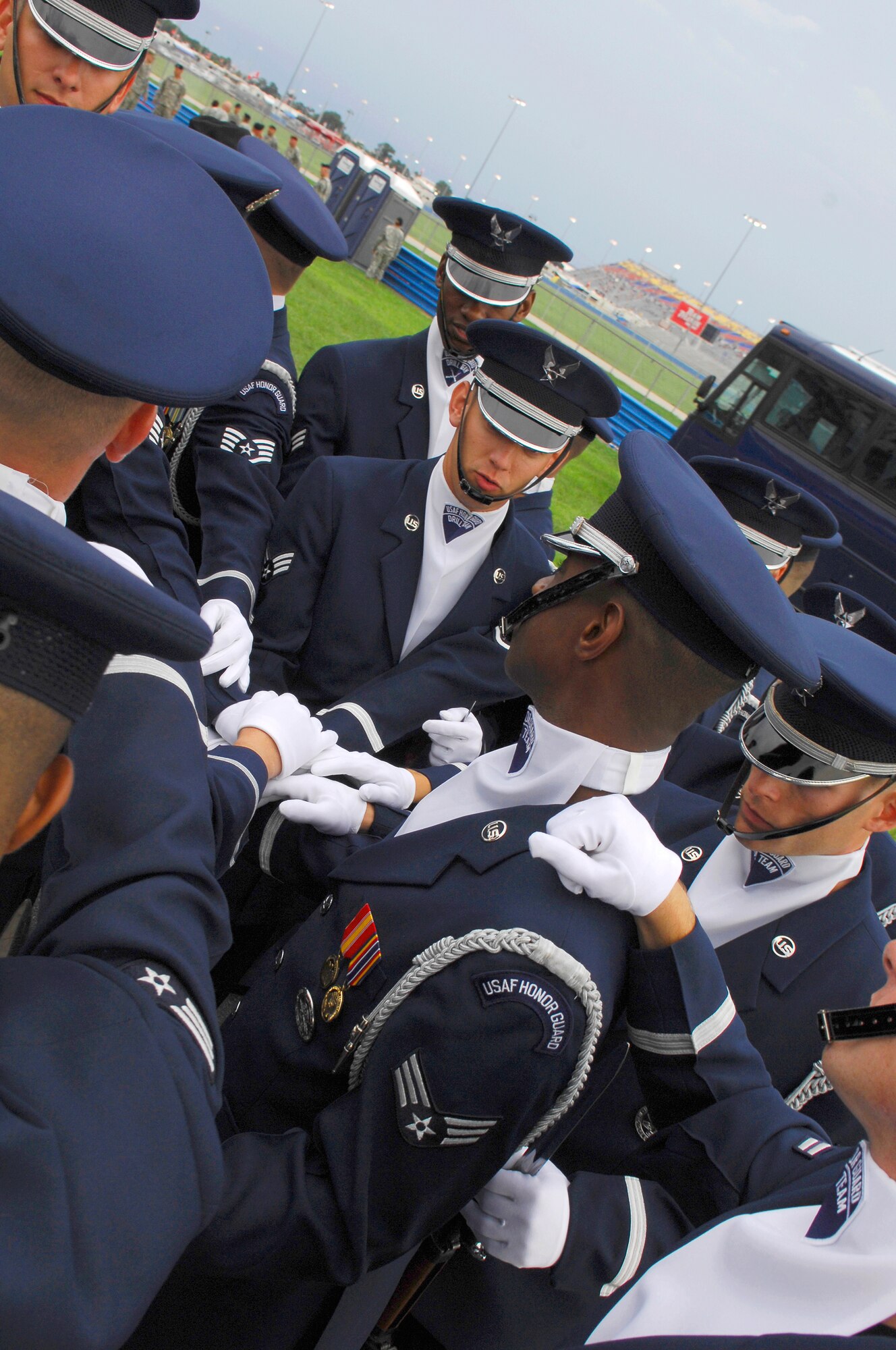 Members of the Drill Team prepare behind pit row before their NASCAR performance.  The Drill Team represented the Air Force during the pre-race events at NASCAR's Pepsi 400 in Daytona, Fla. on July 7th. The Drill Team is the traveling component of the Air Force Honor Guard and tours Air Force bases world wide showcasing the precision of today's Air Force to recruit, retain, and inspire Airmen for the Air Force mission. (U.S. Air Force photo by Airman 1st Class Alexandre Montes)(Released)