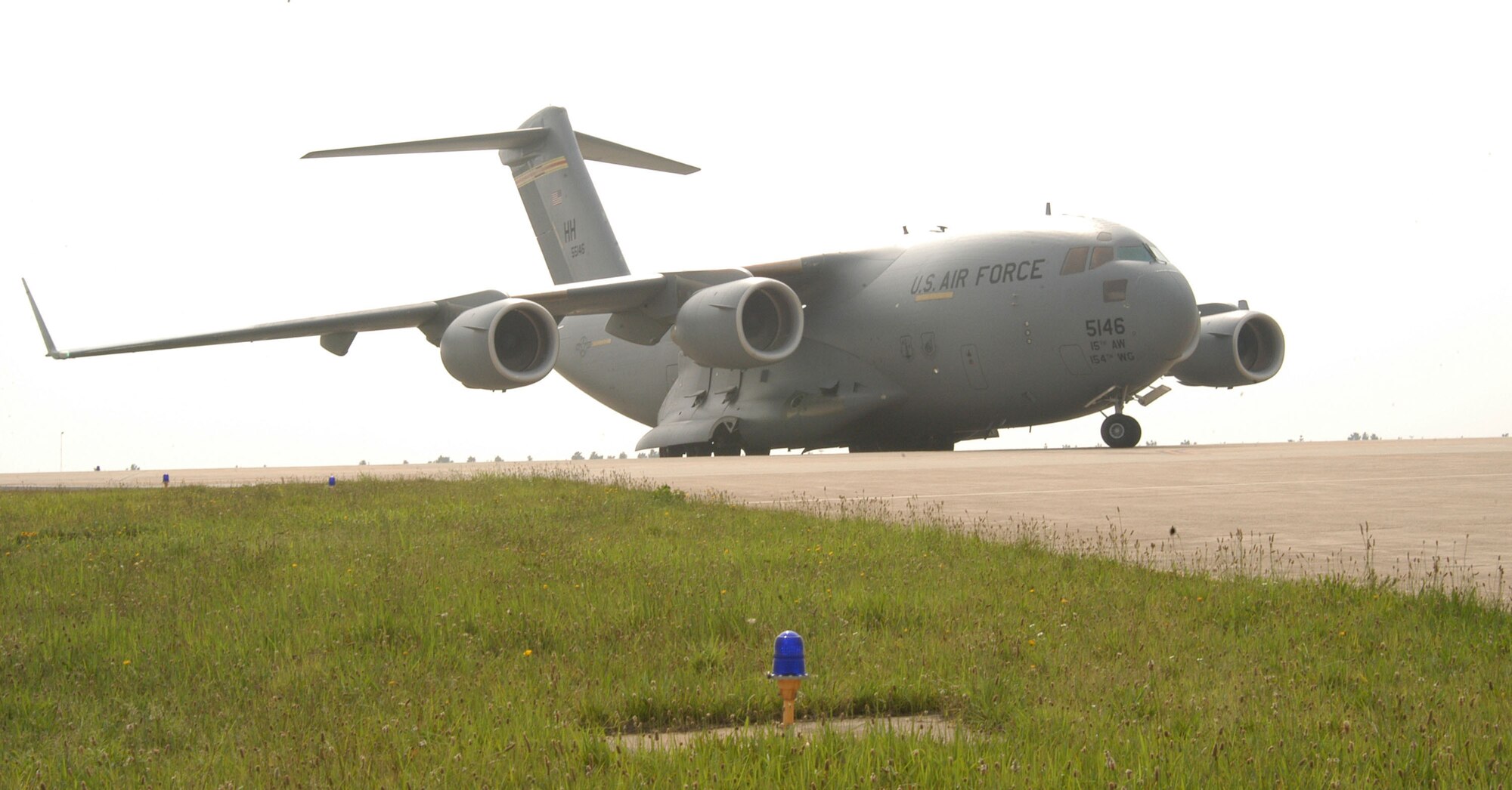 KUNSAN AIR BASE, Republic of Korea -- A C-17 Globemaster III, known as the "Spirit of Hawaii," taxies toward its parking spot on the base's flightline July 8. The aircraft transported more than 40 maintainers and equipment in support of the 555th Expeditionary Fighter Squadron's deployment here. More than 10 F-16 Fighting Falcons assigned to the 555th EFS arrived July 7, adding to the six aircraft already deployed here. (U.S. Air Force photo/Senior Airman Stephen Collier)                           