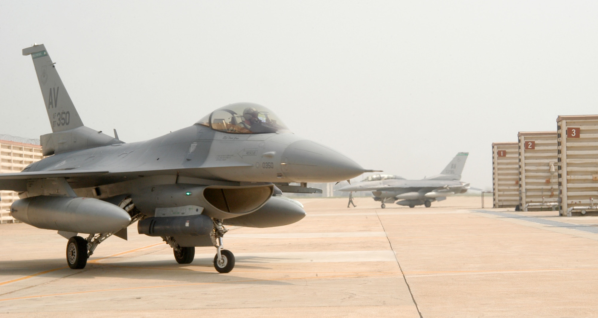 KUNSAN AIR BASE, Republic of Korea -- Pilots from the 555th Expeditionary Fighter Squadron "Triple Nickel" guide their F-16 Fighting Falcons in to Kunsan's Panton pad July 7 after arriving from Alaska. More than 10 aircraft assigned to 555th EFS arrived here from "The Last Frontier" state after being hampered by poor weather conditions. The Triple Nickel is deployed to Kunsan as part of a force posture adjustment in the Northeast Asia region. (U.S. Air Force photo/Senior Airman Stephen Collier)                                                                                                