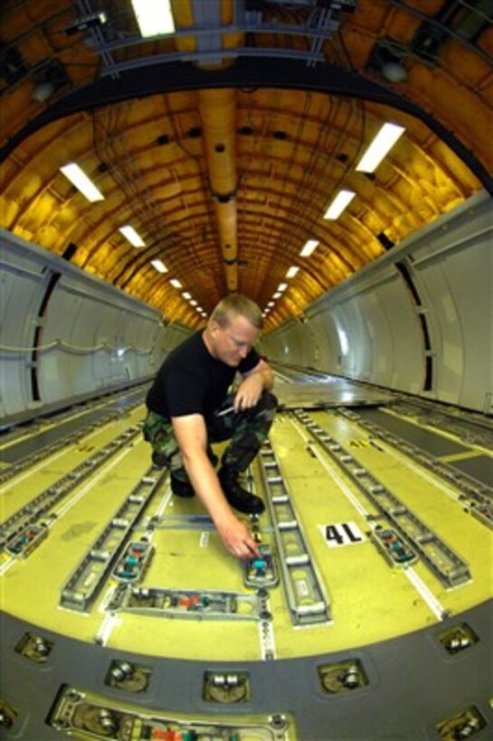 U.S. Air Force Staff Sgt. Darren Dobelman adjusts the tracks in the cargo bay of a KC-10 Extender aircraft at Travis Air Force Base, Calif., on June 28, 2007.  Dobelman is attached to the 660th Aircraft Maintenance Squadron.  