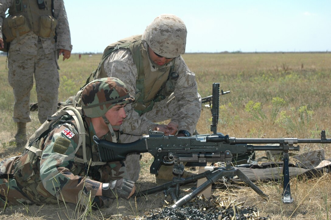 Corporal Christian Perez, G Company, 2nd Battalion, 23rd Marine Regiment, assists Georgian Corporal Cecil Kharaishvili in loading rounds in the M-240G machine gun. The Marines and Georgians familiarized and fired weapons from their respective countries. Weapons included the M-16A4, AK47, AK74, 9 mm pistol, M-203 grenade launcher, AT-4 and Rocket Propelled Grenade launcher. Exercise Sea Breeze is in its tenth year and focuses on strengthening partnerships and fostering maritime safety and security capabilities to conduct peacekeeping operations in the Black Sea region. With 14 nations participating on land and at sea the U.S. forces here focused on ground training with service members from Moldova, Macedonia, Georgia, Armenia, Germany and the Ukraine, the host of the exercise.