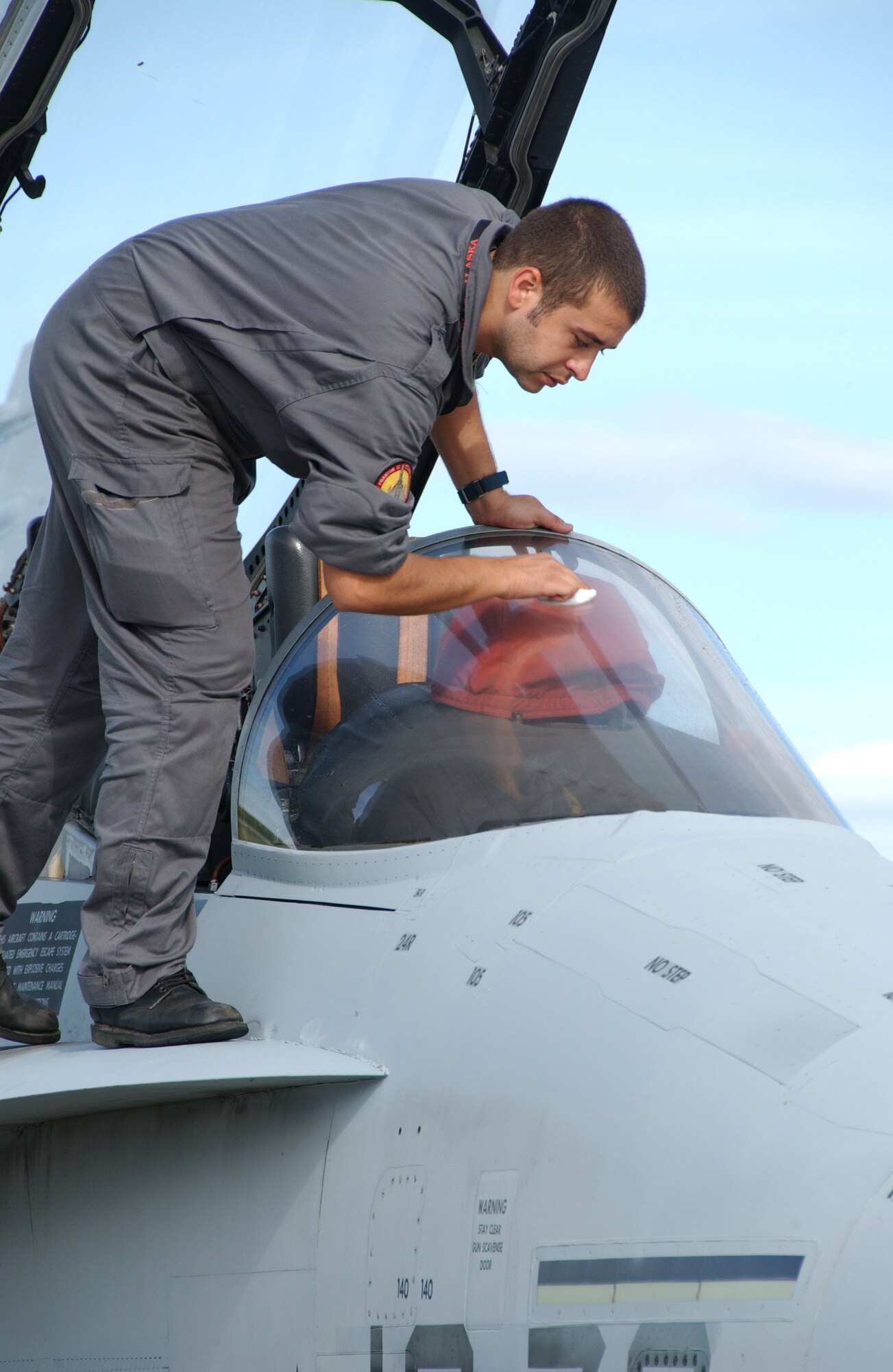EIELSON AIR FORCE BASE, Alaska -- Cpl Javier Suarez, 12th Fighter Wing, Torrejon Air Base, of the Spanish Air Force cleans the Canopy of an F-18 July 10, 2007. The Spanish are one of a few different countries that will be participating in Red Flag-Alaska 07-3, these exercises are conducted on the Pacific Alaskan Range Complex with air operations flown out of Eielson and Elmendorf Air Force bases in Alaska. (U.S. Air Force photo by Airman 1st Class Christopher Griffin) 