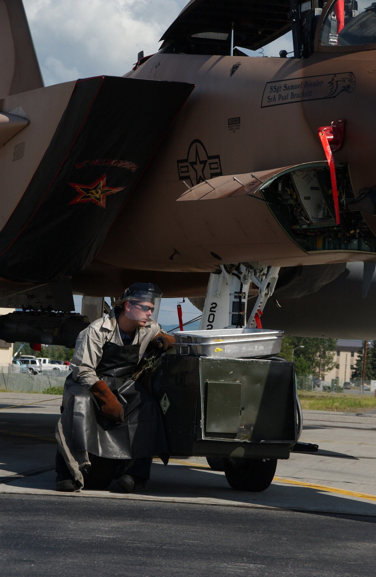 EIELSON AIR FORCE BASE, Alaska -- Airman 1st Class Zachary Garretson, 57th Aircraft Maintenance Squadron, Nellis Air Force Base, Nev., services the liquid oxygen system of an F-15C Aggressor on the Eielson AFB, Alaska flight line July 9. Airman Garretson is taking part of the Red Flag-Alaska 07-3, a multi-service, multi-platform coordinated, which runs through the July 27.  (U.S. Air Force photo by Airman 1st Class Christopher Griffin)
