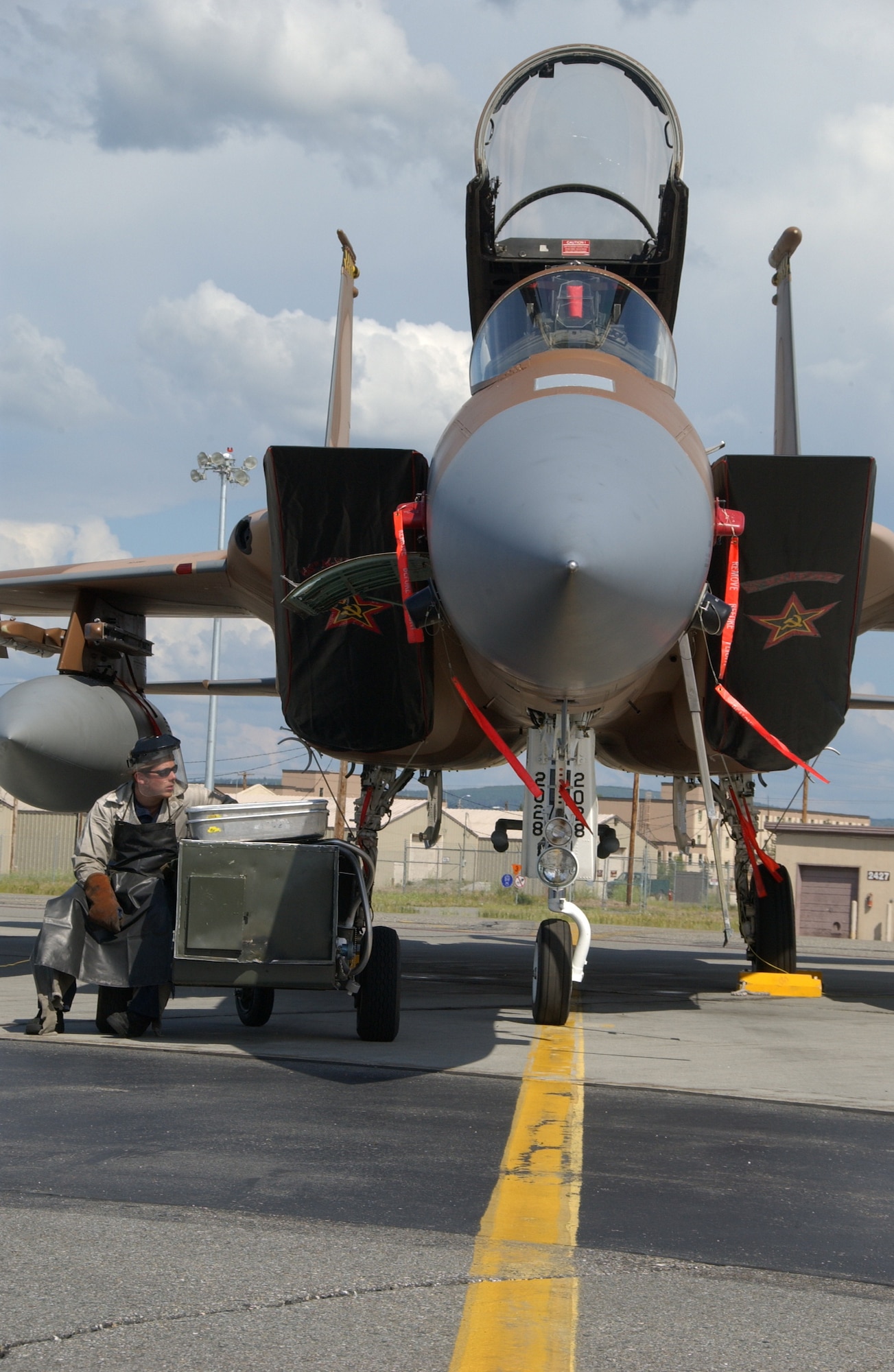 EIELSON AIR FORCE BASE, Alaska -- Airman 1st Class Zachary Garretson, 57th Aircraft Maintenance Squadron, Nellis Air Force Base, Nev., services the liquid oxygen system of an F-15C Aggressor on the Eielson AFB, Alaska flight line July 9. Airman Garretson is taking part of the Red Flag-Alaska 07-3, a multi-service, multi-platform coordinated, which runs through the July 27.  (U.S. Air Force photo by Airman 1st Class Christopher Griffin)