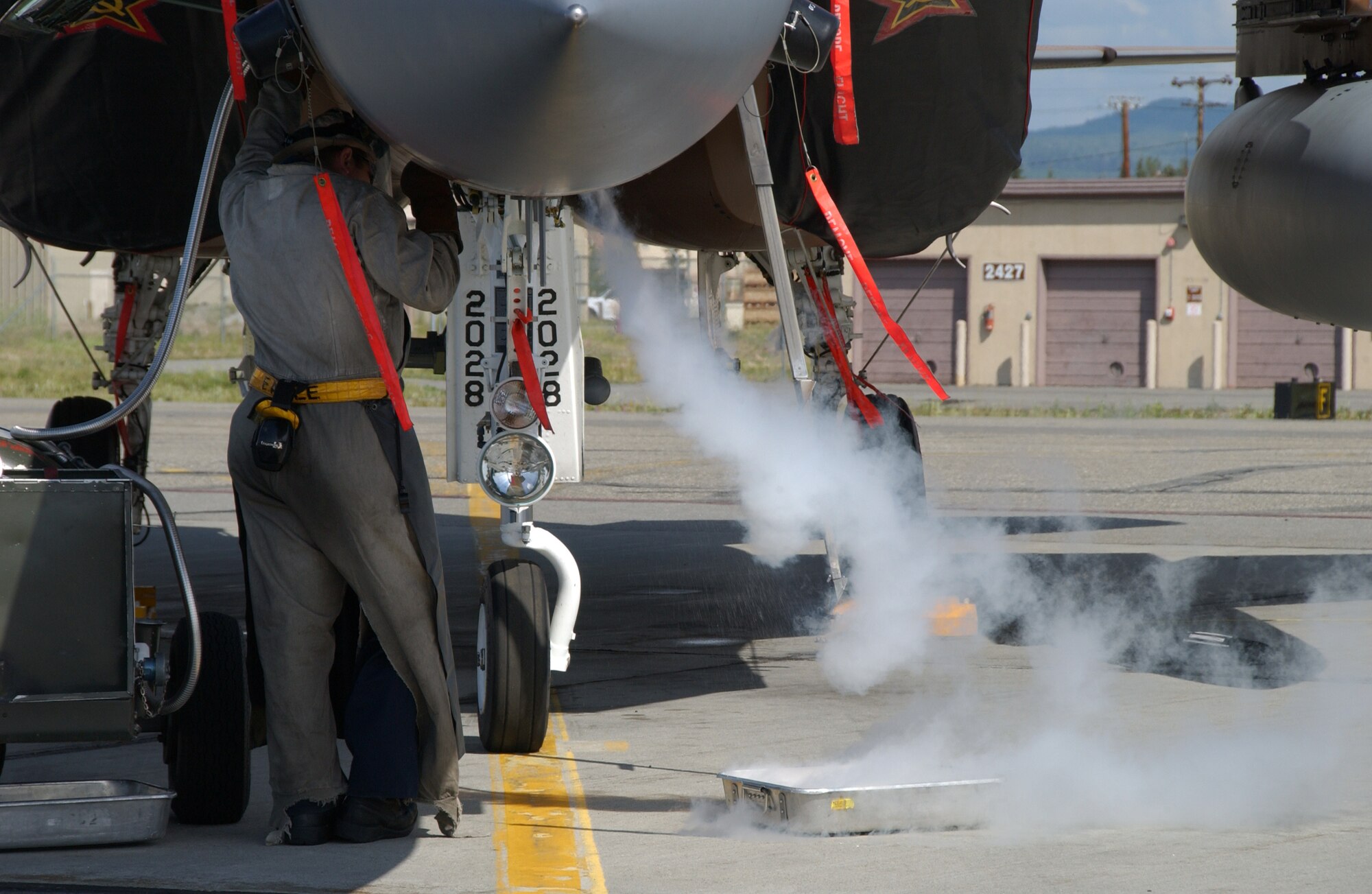 EIELSON AIR FORCE BASE, Alaska -- Airman 1st Class Zachary Garretson, 57th Aircraft Maintenance Squadron, Nellis Air Force Base, Nev., services the liquid oxygen system of an F-15C Aggressor on the Eielson AFB, Alaska flight line July 9. Airman Garretson is taking part of the Red Flag-Alaska 07-3, a multi-service, multi-platform coordinated, which runs through the July 27.  (U.S. Air Force photo by Airman 1st Class Christopher Griffin)