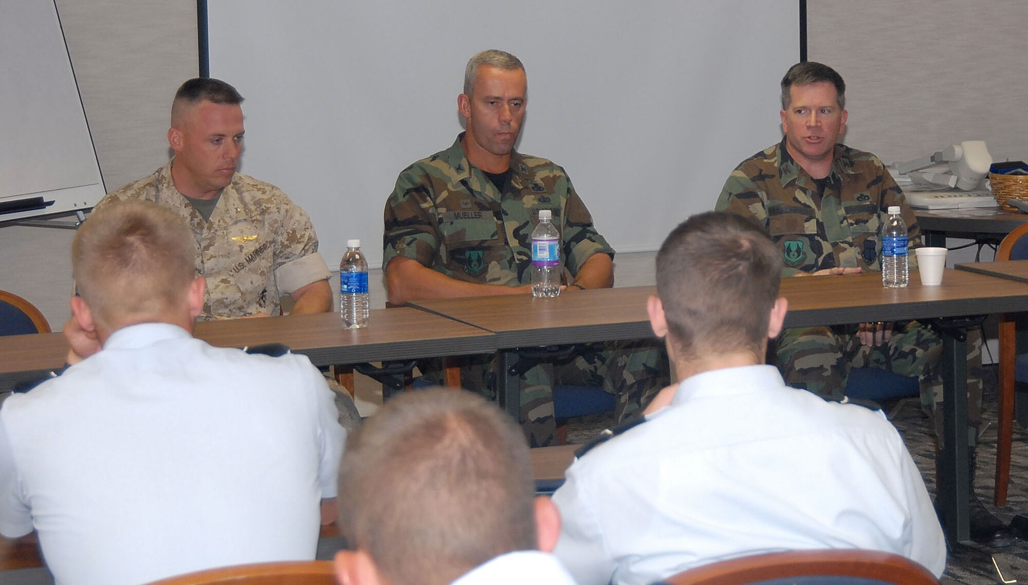 Col. Bryan Gallagher (right), 95th Air Base Wing commander, Col. Mark Mueller (center), 412th Maintenance Group commander, and Marine Lt. Col. Thomas McCarthy (left), Marine Aircraft Group Detachment B commander, talk to Air Force Reserve Officers' Training Corps cadets during a senior leader seminar at the Conference Center here Tuesday. The commanders covered topics such as force reductions, joint service operations, the future of warfare and career devlopment advice. (Photo by Senior Airman Jason Hernandez)