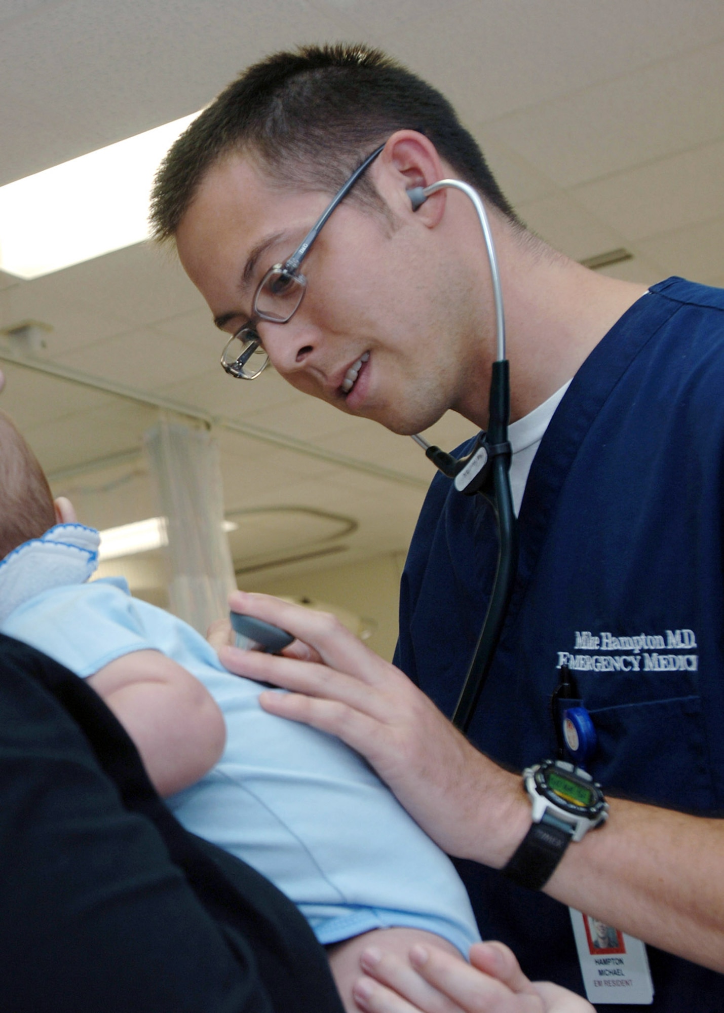 Capt.(Dr.) Michael Hampton, a third-year emergency medicine resident, checks an infant's vitals June 25 in the emergency department at Wilford Hall Medical Center, Lackland Air Force Base, Texas.  Dr. Hampton is assigned to the 59th Emergency Medicine Squadron. (U. S. Air Force photo/Staff Sgt. Ruth Stanley)