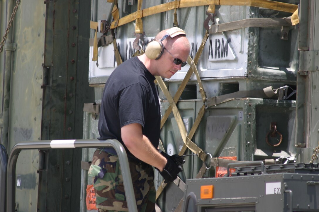 HICKAM AFB, Hawaii - Tech. Sgt. Larry Adams, ramp services specialist from the 87th Aerial Port Squadron deployed from Wright-Patterson AFB, Ohio unloads a cargo pallet from a C-17 aircraft onto a 40-K loader at Hickam AFB, Hawaii. (U.S. Air Force photo/Master Sgt. Doug Moore)
