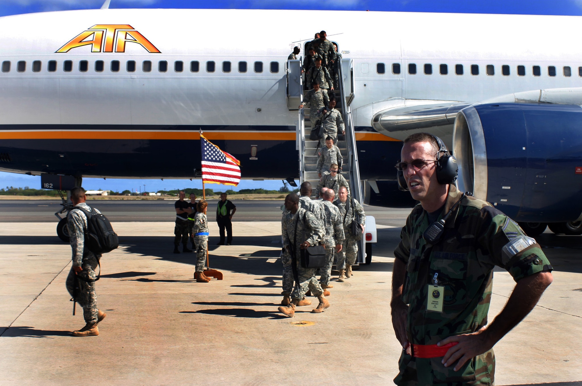 HICKAM AFB, Hawaii - Master Sgt. Edward Kirker, Air Terminal Operations Center controller from the 87th Aerial Port Squadron deployed from Wright-Patterson AFB, Ohio meets a 747 aircraft returning from Balad with 195 U.S. Army troops.  The troops are returning to Scofield Barracks after a year long overseas tour. (U.S. Air Force photo/Master Sgt. Doug Moore)