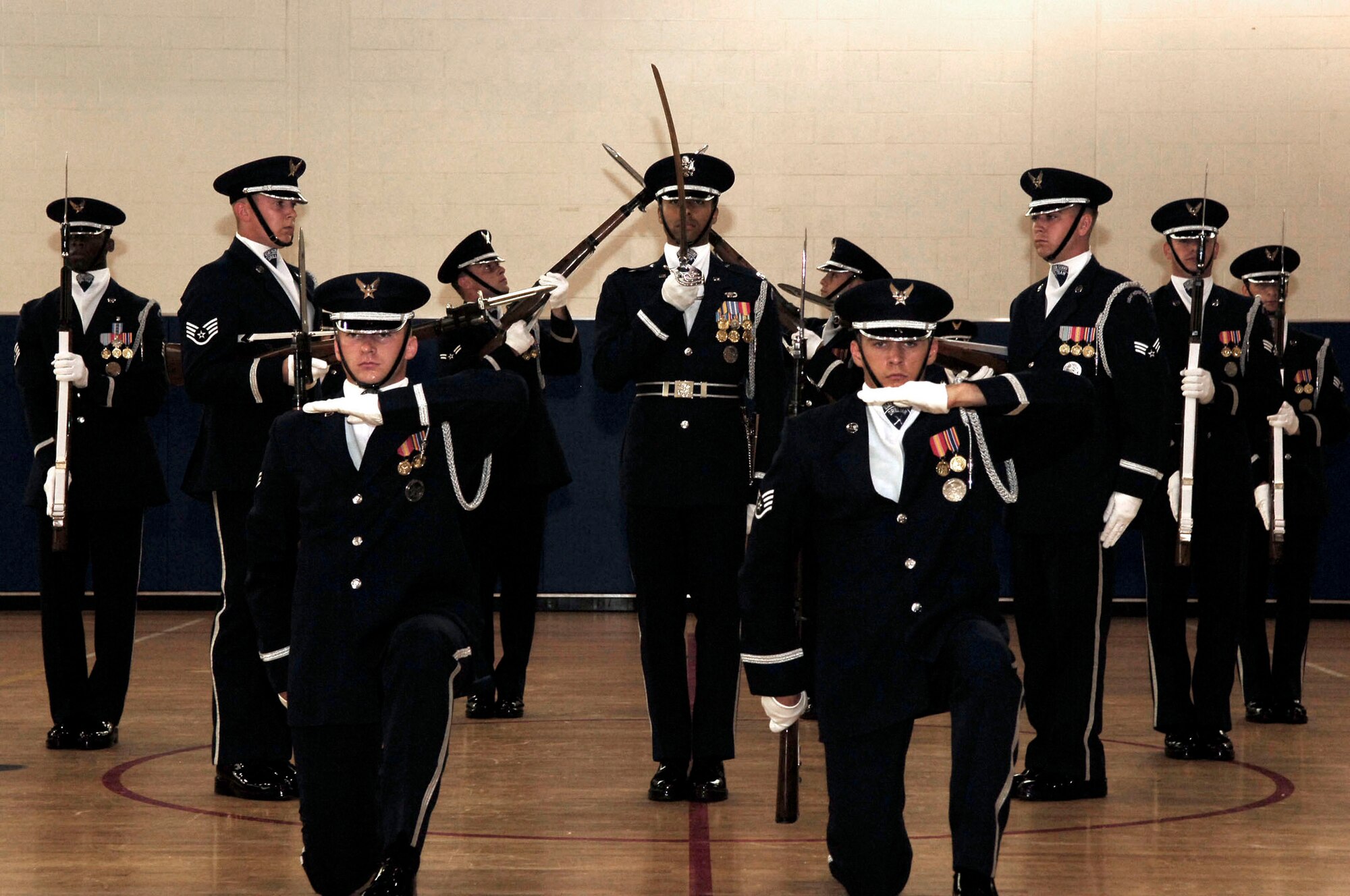 The U.S. Air Force Honor Guard Drill Team performs a drill at the base fitness center July 9. The Drill team tours with the large 16-man sequence, featuring a professionally choreographed 20-minute routine full of weapon manuals, tosses, and complex weapon exchanges. (U.S. Air Force photo by Senior Airman Bradley Lail)