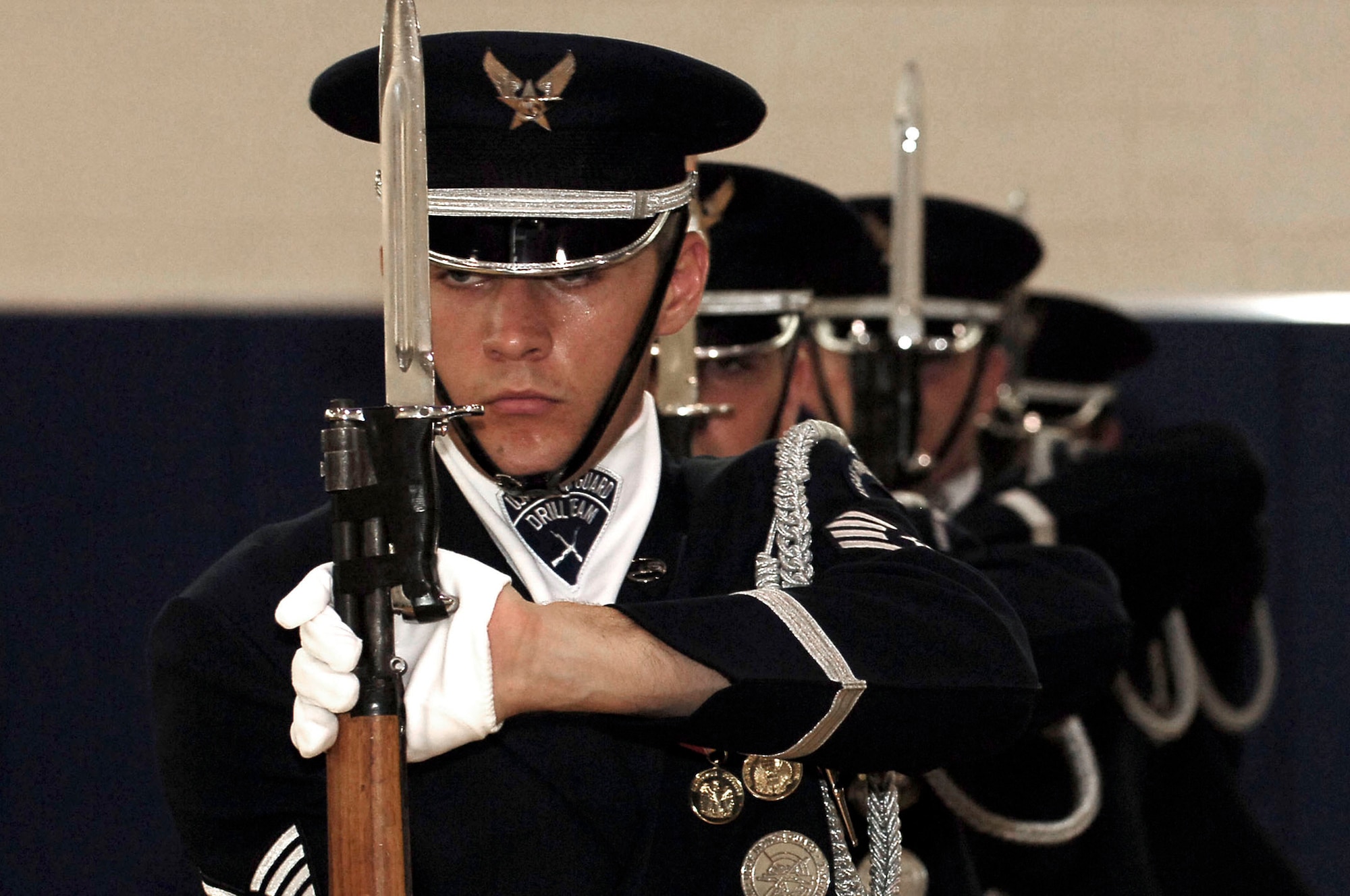 The U.S. Air Force Honor Guard Drill Team performs a drill at the base fitness center July 9. The Drill team tours with the large 16-man sequence, featuring a professionally choreographed 20-minute routine full of weapon manuals, tosses, and complex weapon exchanges. (U.S. Air Force photo by Senior Airman Bradley Lail)