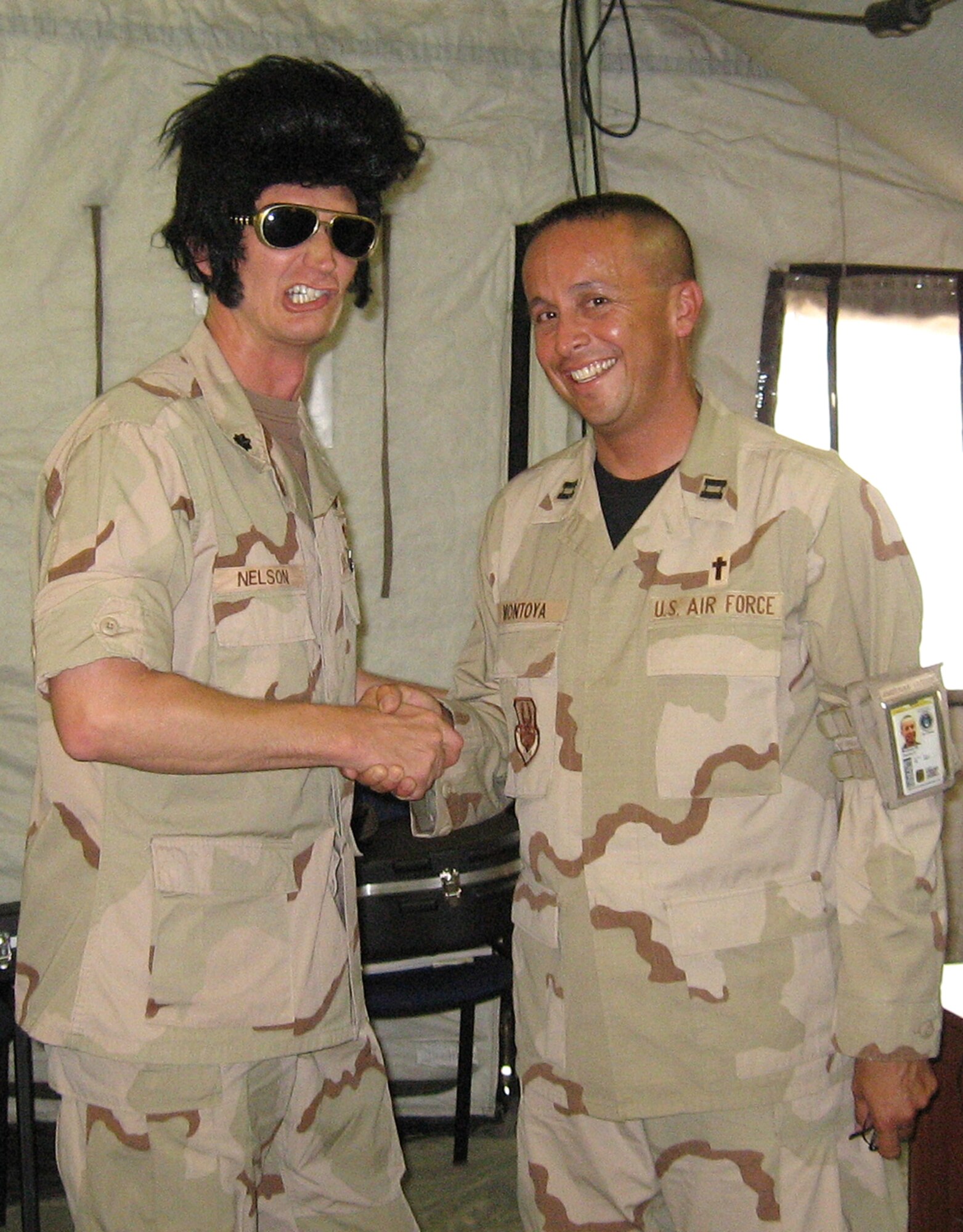Chaplain (Capt.) Rick Montoya, 14th Flying Training Wing, greets Elvis, Lt. Col. Paul Nelson, 376 EMDG Deputy Group commander, while deployed in the Republic of Kyrgyzstan. (U.S. Air Force Photo)
