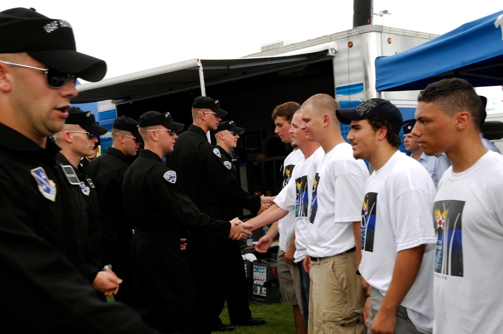 Members of the Air Force Drill Team congratulate new delayed enlistees before the Pepsi 400 NASCAR race July 7 at Daytona International Speedway in Florida. The team joined the Secretary of the Air Force Michael W. Wynne in celebrating the Air Force's 60th anniversary with NASCAR fans and representing the Air Force as a part of the "America Supports You" program honoring all servicemembers for the race weekend. (U.S. Air Force photo/Airman 1st Class Alexandre Montes) 
