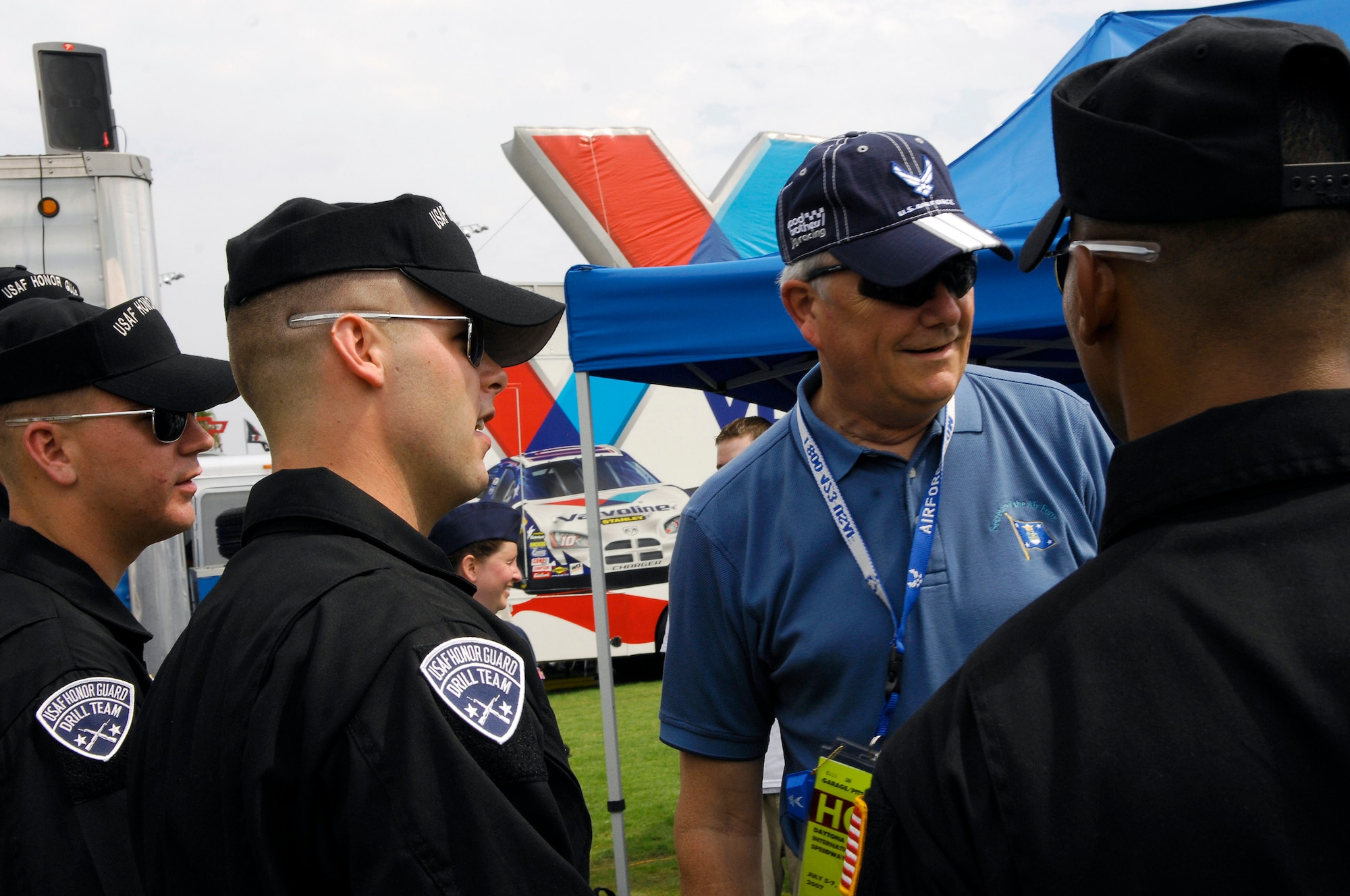 Secretary of the Air Force Michael W. Wynne and members of the Air Force Drill Team congratulate the new delayed enlistees before the NASCAR race July 7 at Daytona International Speedway in Florida. The team joined the secretary in celebrating the Air Force's 60th anniversary with NASCAR fans and representing the Air Force as a part of the "America Supports You" program honoring all servicemembers for the race weekend. (U.S. Air Force photo/Airman 1st Class Alexandre Montes) 
