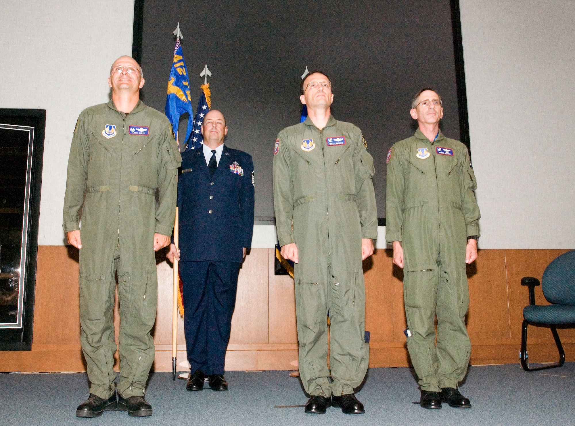 From left: Col. Arnie Bunch, 412th Test Wing commander, Master Sgt. Michael Brown, 412th Operations Support Squadron tower chief, Col. Terry Luallen and Col. Andre Gerner stand at attention during the U.S. Air Force Test Pilot School change of command ceremony at the Dick Scobee Auditorium on July 6. Colonel Luallen assumed command from Colonel Gerner. (Photo by Chad Bellay)