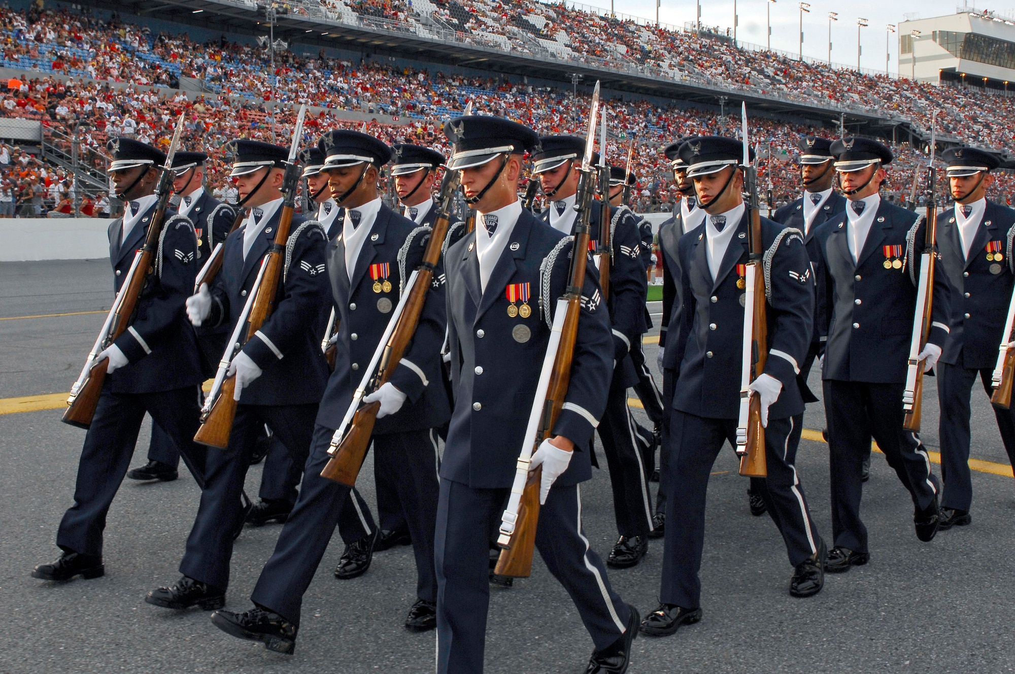 Members of the Air Force Drill Team march out of pit row following their 16-man performance before the NASCAR race July 7 at the Daytona International Speedway in Florida. More than 150,000 watched as TNT broadcast the Air Force performance live during the pre-race events at NASCAR's Pepsi 400. The drill team is the traveling component of the Air Force Honor Guard and tours Air Force bases world wide showcasing the precision of today's Air Force to recruit, retain and inspire Airmen for the Air Force mission. (U.S. Air Force photo/Airman 1st Class Alexandre Montes)