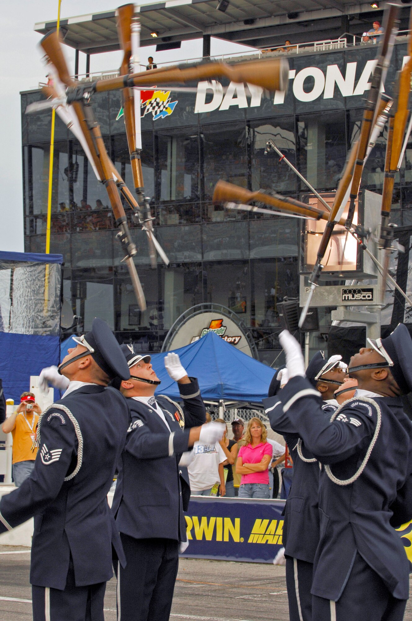 Members of the Air Force Drill Team perform their 16-man sequence in front of more than 150,000 spectators during the pre-race events at NASCAR's Pepsi 400 July 7 in Daytona, Fla. The drill team joined Secretary of the Air Force Michael W. Wynne to represent the Air Force as a part of the "America Supports You" program honoring all servicemembers for the race weekend. The NASCAR event kicked-off the team's current tour, which continues as they visit MacDill Air Force Base and Hurlburt Field, both in Florida. (U.S. Air Force photo/Airman 1st Class Alexandre Montes)