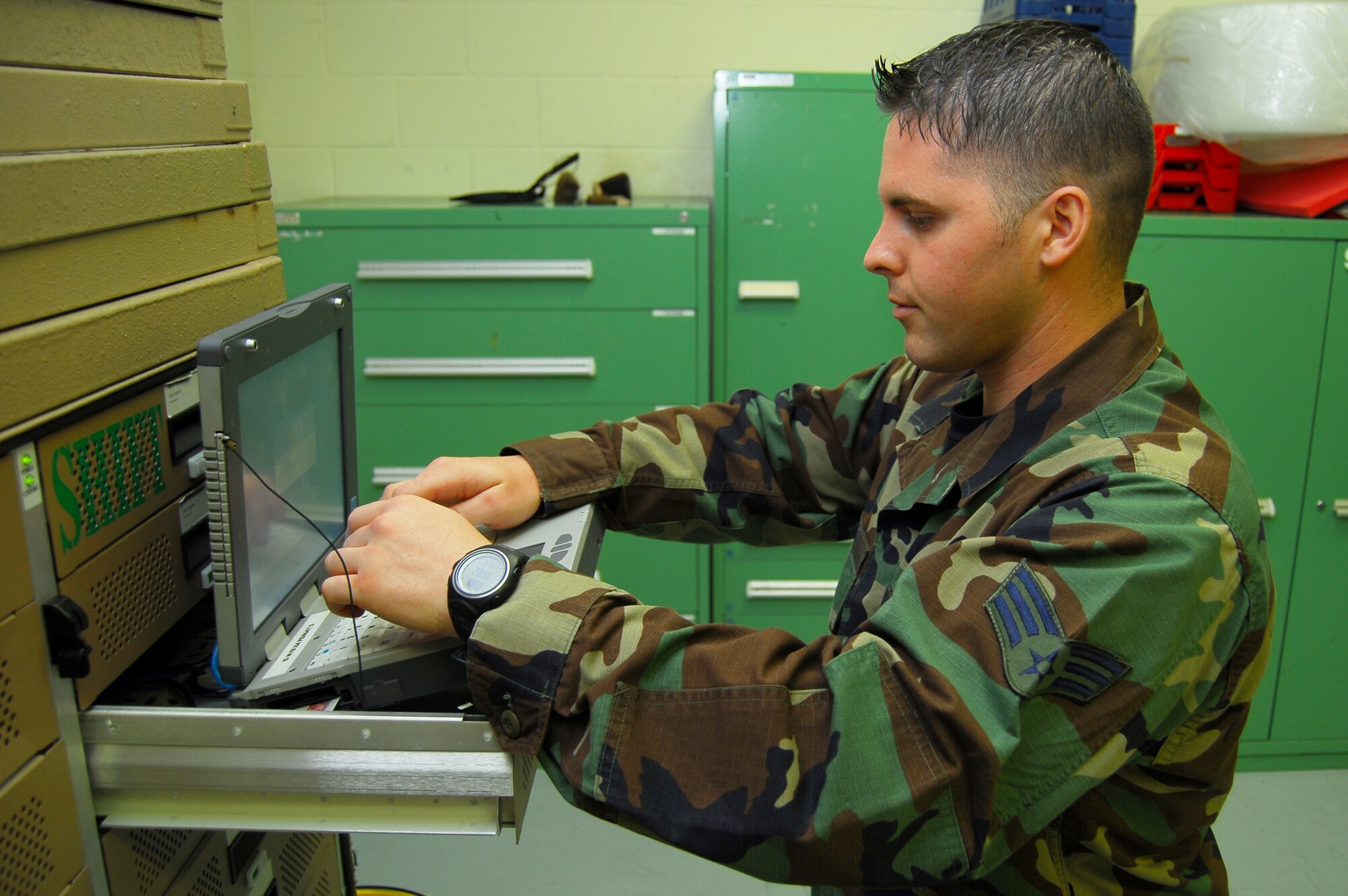 Senior Airman Landon Lenard, 723rd Aircraft Maintenance Squadron, HH-60G support technician, logs into a GoBook ruggedized laptop at its docking and charging station July 10. The laptops allow flightline workers at Moody Air Force Base, Ga., to wirelessly log into automated systems for ordering parts and scheduling specialized repairs on aircraft. (U.S. Air Force photo by Tech. Sgt. Parker Gyokeres)