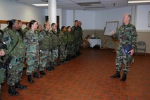 MINOT AIR FORCE BASE, N.D. -- Chaplain (Col.) Brian Hunter, Air Force Space Command command chaplain, addresses members from the 91st Security Forces Group during a shift change July 10. Chaplain Hunter thanked the Airmen for their service and explained how chaplains serve side-by-side with them, leading worship services and observances and providing pastoral care, (U.S. Air Force photo by Airman 1st Class Joe Rivera)