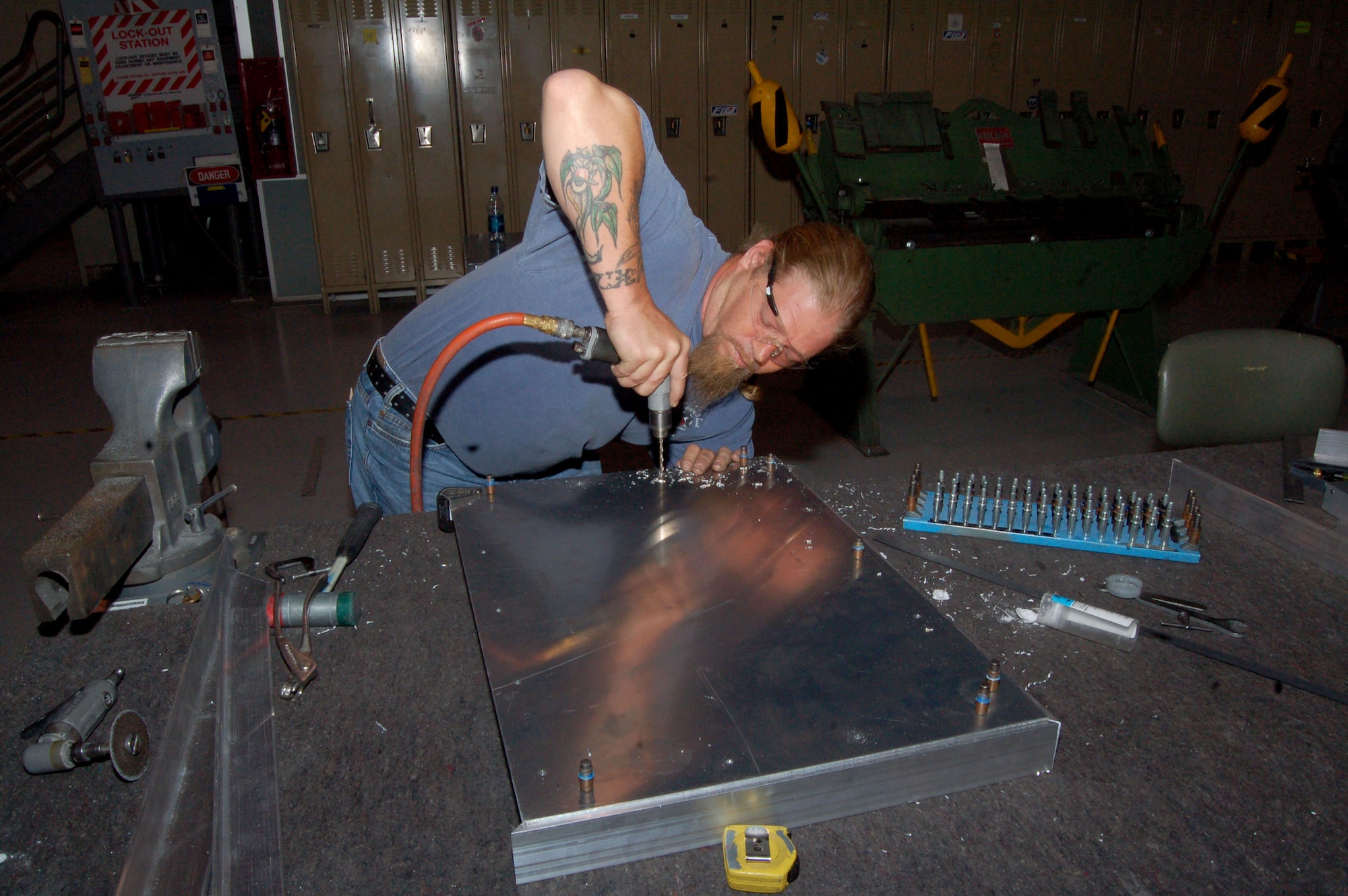 Christopher Ball, an aircraft structural mechanic with the 412th Maintenance Squadron, drills holes in aluminum components that will become a wheeled platform for carrying tools. The metals the shop works with include aluminum, steel and titanium and can range from ten thousandths of an inch up to one inch thick. (Photo by Senior Airman Jason Hernandez)