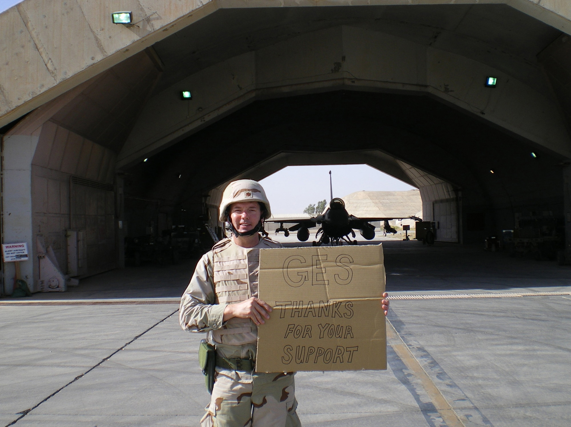 Maj. Dave Edwards shows his appreciation to the school back home who continues to support his children while he is deployed. The major received numerous cards from the school and brought home a flag that was flown in an F-16 on a regular mission in Southwest Asia. Maj. Dave was assigned to the 332nd Expeditionary Aircraft Maintenance Squadron in Southwest Asia. (U.S. Air Force Photo)