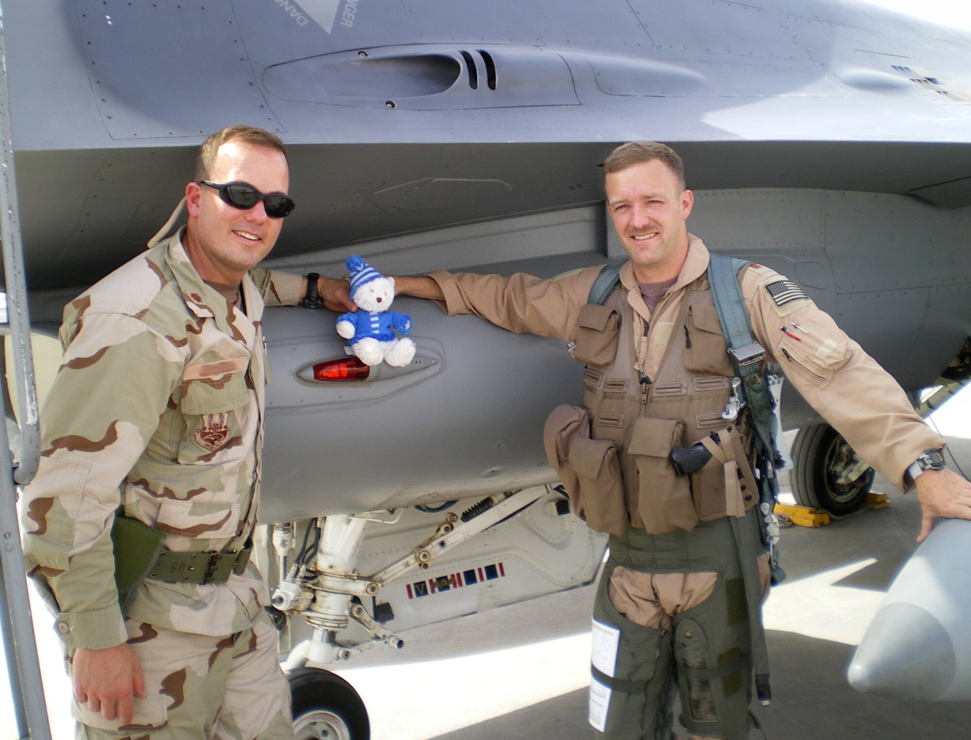 Maj. Dave Edwards gives Lars, Jr., (center) support during a visit with a deployed F-16 pilot, Maj. Steve Nelson. Having LJ, as she's called for short, deployed with the major to keep him safe and ensure his daughter back home that they are both fine and having many adventures together. Both officers were assigned to the 332nd Expeditionary Aircraft Maintenance Squadron in Southwest Asia. (U.S. Air Force Photo)