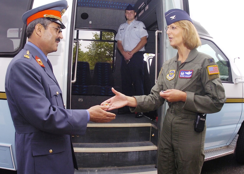 Col. Margaret H. Woodward, 89th Airlift Wing commander, presents Maj. Gen. Mohammad Dawran, Afghanitan National Army Air Corps commander, with her personal coin during his visit to the 89 AW, July 5.