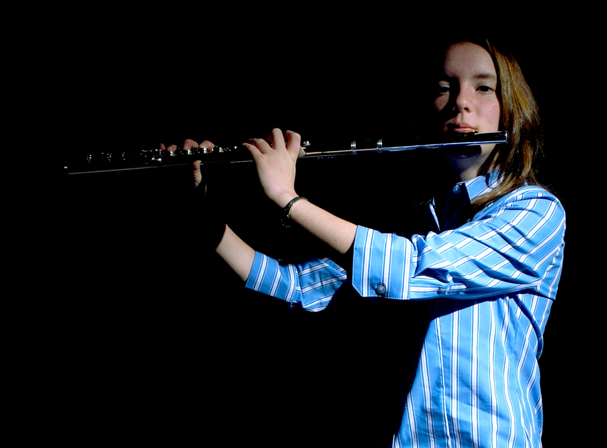 MOUNTAIN HOME AIR FORCE BASE, Idaho -- Heidi Peck, daughter of Chief Master Sgt. Norman and Debi Peck, poses with her flute here July 6. Diagnosed with Autosomal Recessive Polycystic Kidney Disease at birth, the 16-year-old teenager continues to fight back through her love of music, in particular her flute playing, which helps exercise her lungs and keep her healthy. (U.S. Air Force photo/Airman 1st Class Ryan Crane)