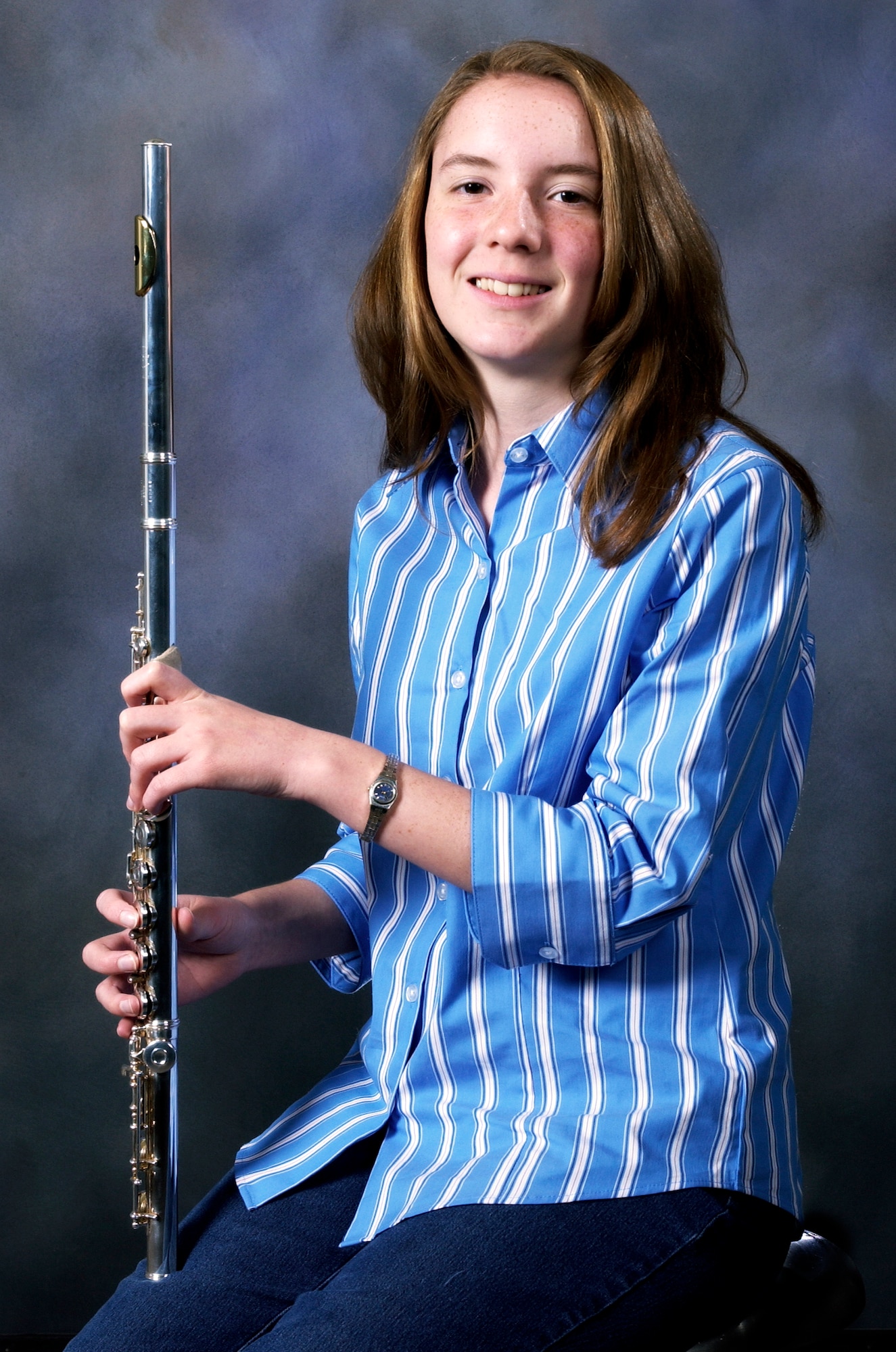 MOUNTAIN HOME AIR FORCE BASE, Idaho -- Heidi Peck, daughter of Chief Master Sgt. Norman and Debi Peck, poses with her flute here July 6. Diagnosed with Autosomal Recessive Polycystic Kidney Disease at birth, the 16-year-old teenager continues to fight back through her love of music, in particular her flute playing, which helps exercise her lungs and keep her healthy. (U.S. Air Force photo/Airman 1st Class Ryan Crane)