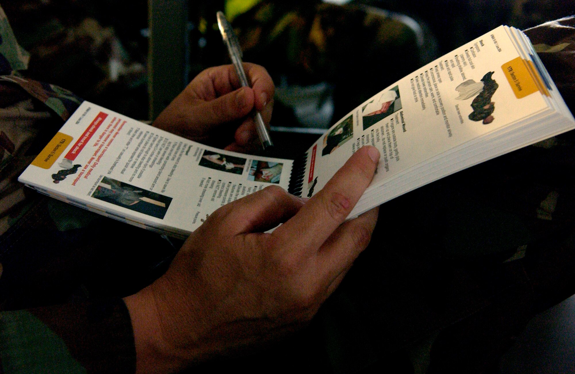 Tech. Sgt. Sean White, 6th Communications Squadron photographer, looks over his Airman's Manual during a Self Aide and Buddy Care class. MacDill servicemembers traveled to Gulfport, Miss., June 24, for a four-day ability to survive and operate training course in preparation for the upcoming Operational Readiness Inspection. (U.S. Air Force photo by Senior Airman Bradley Lail)